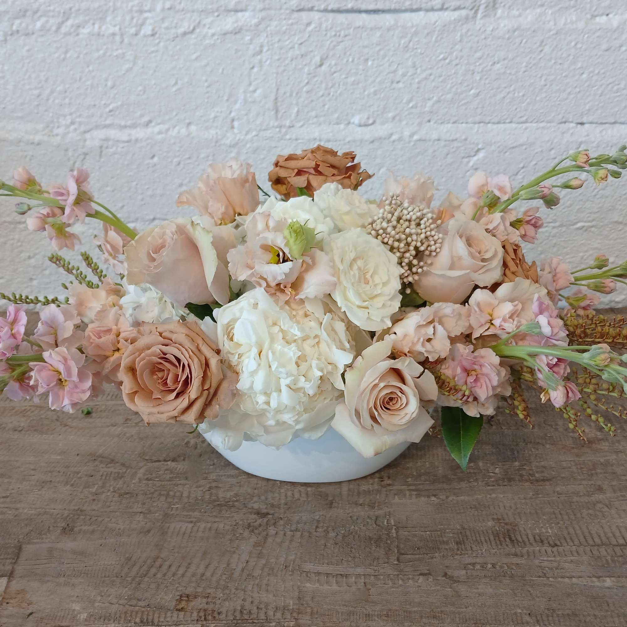 Soft Embrace is a serene and elegant floral arrangement that brings a