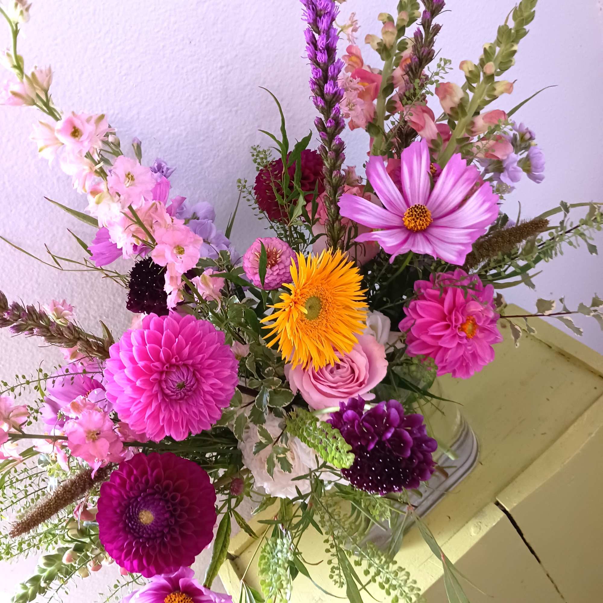 A mix of wildflowers arranged in a clear vase, perfect for the