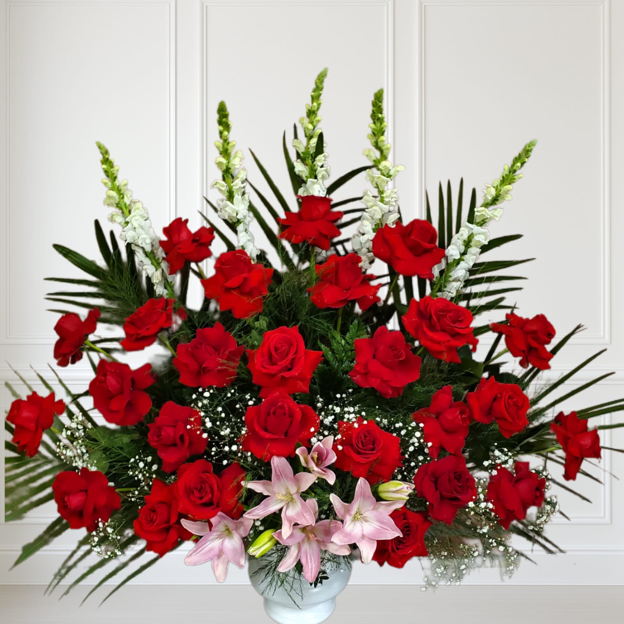 Red roses, pink lilys and white snaps.