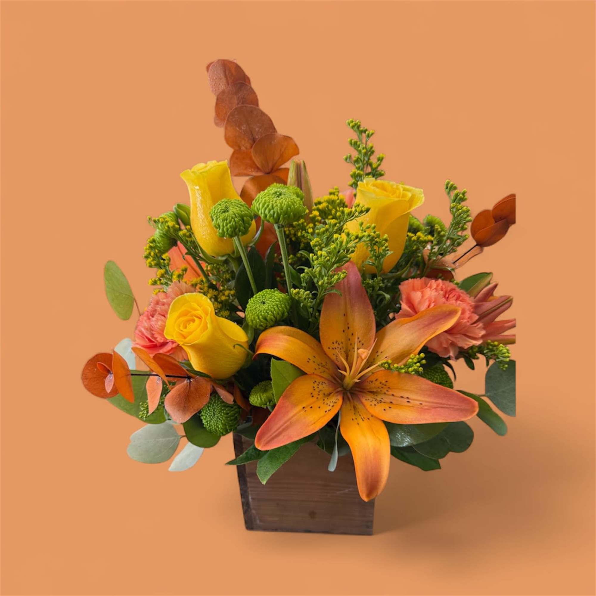 Wood Box full of colorful fall tones.
Includes roses, lilies carnations, button mums