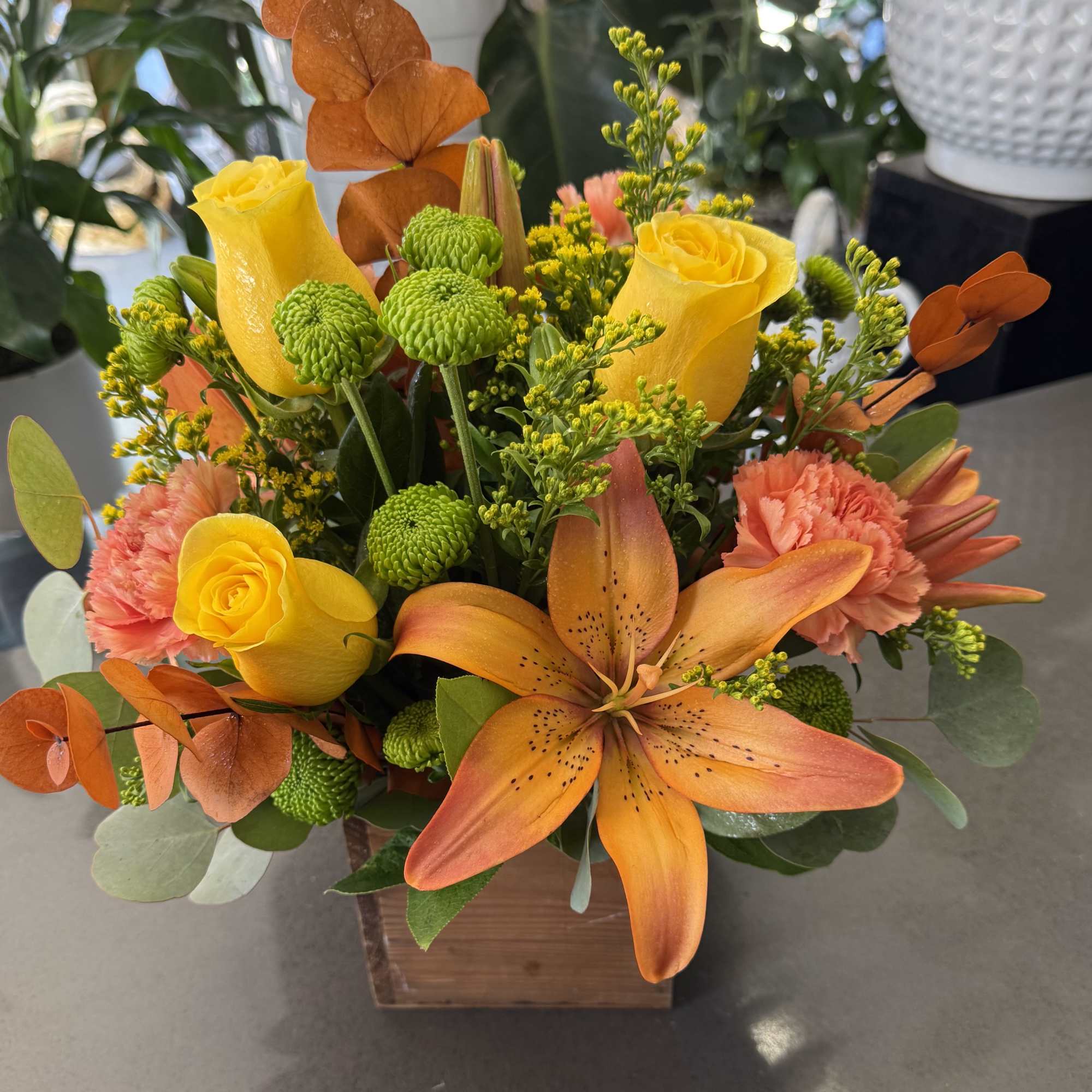 Wood Box full of colorful fall tones.
Includes roses, lilies carnations, button mums