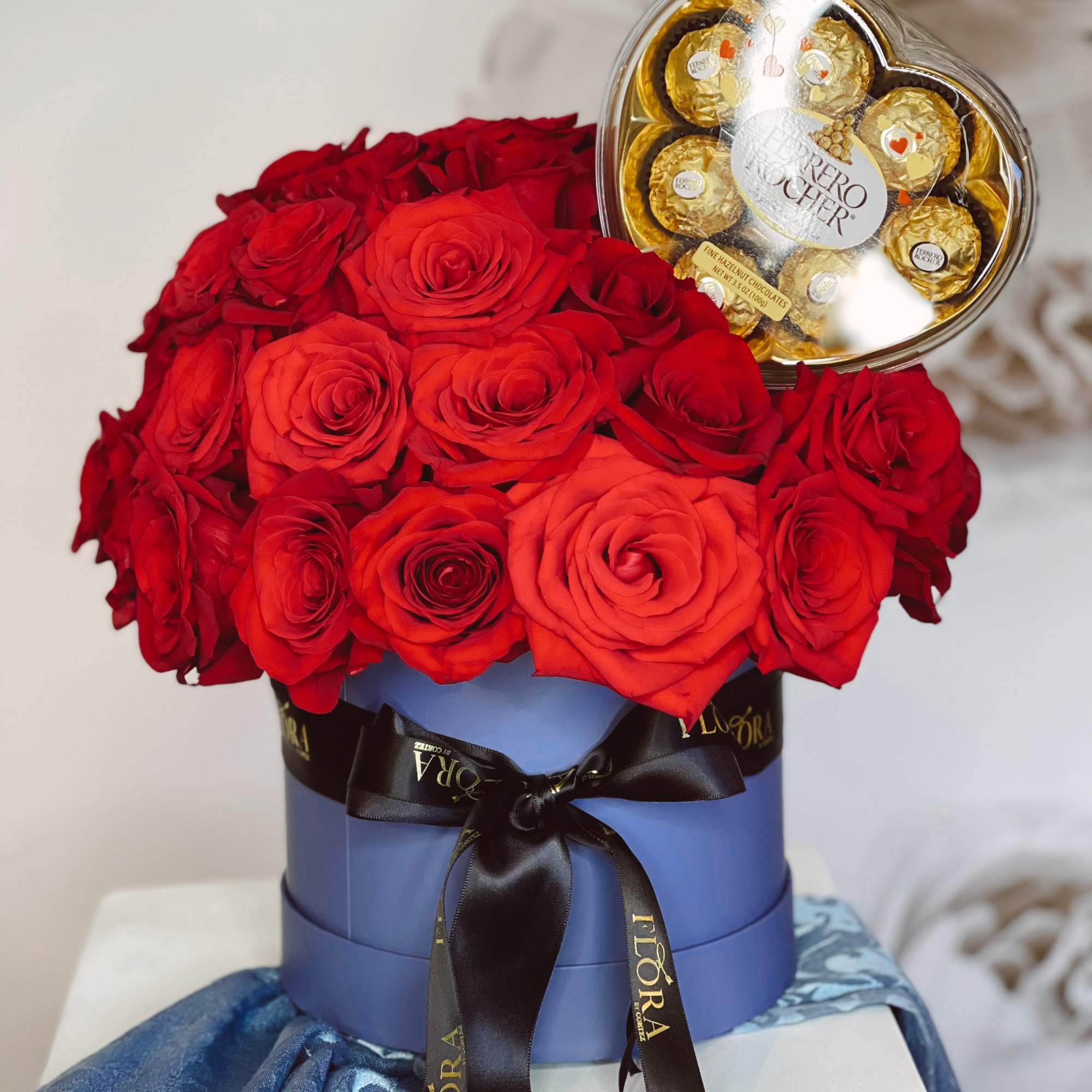 Make a bold statement with 70 red roses, a small Grey Goose