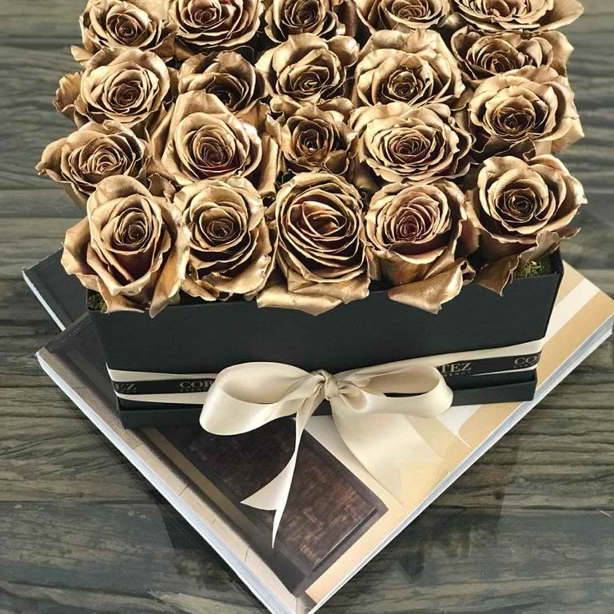 Elegant box filled with approximately 20 gold roses, offering a luxurious and