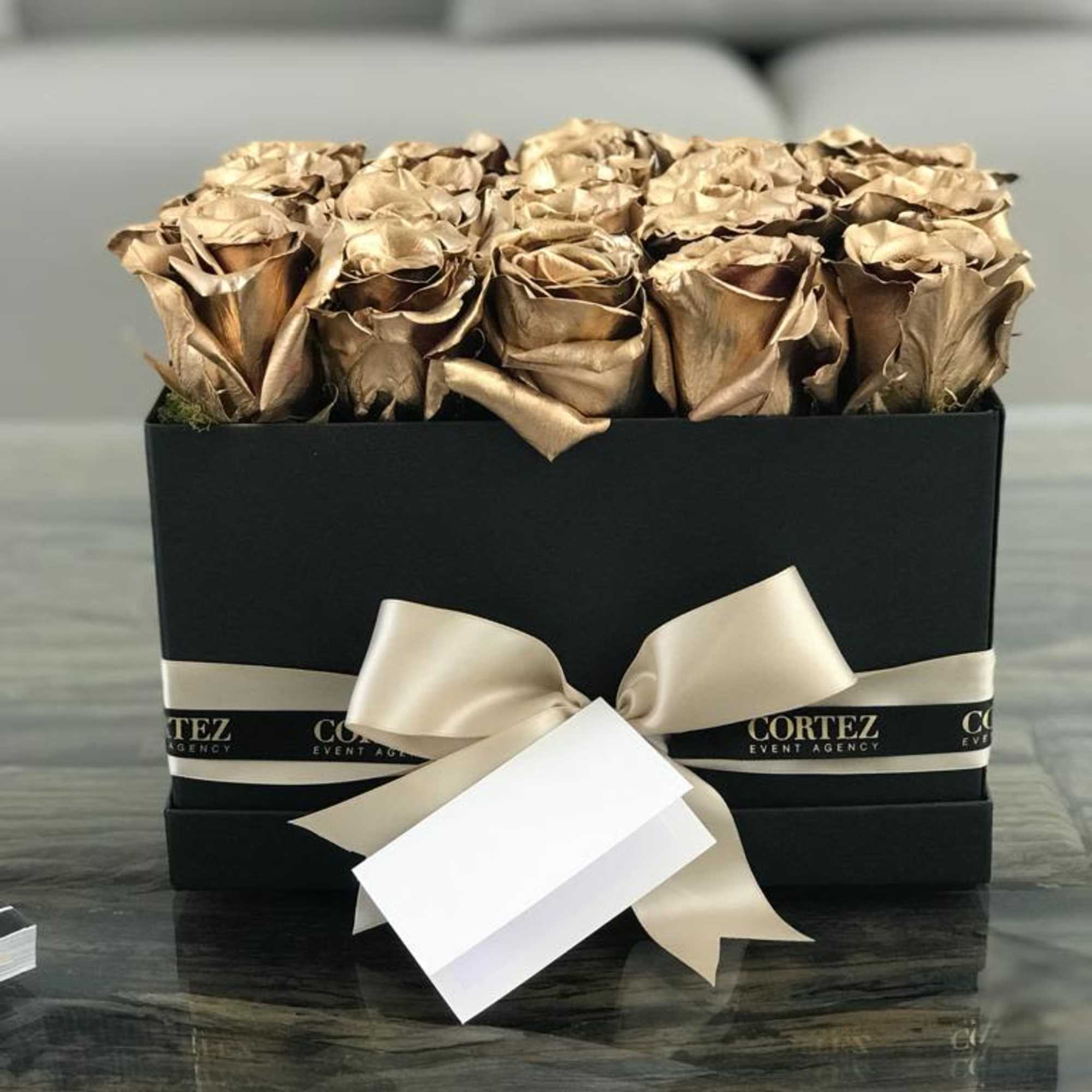 Elegant box filled with approximately 20 gold roses, offering a luxurious and