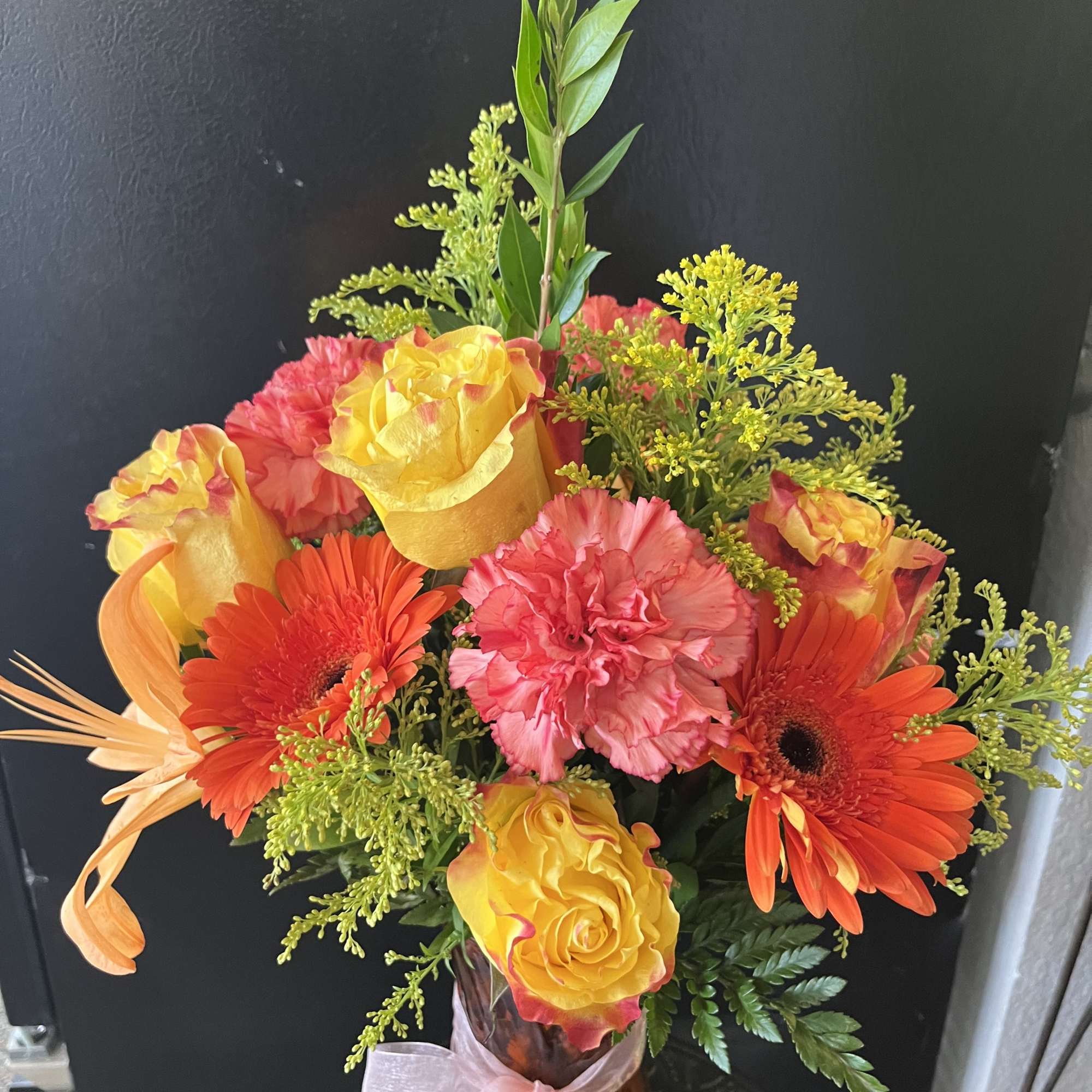fresh fall color flowers in orange vase 