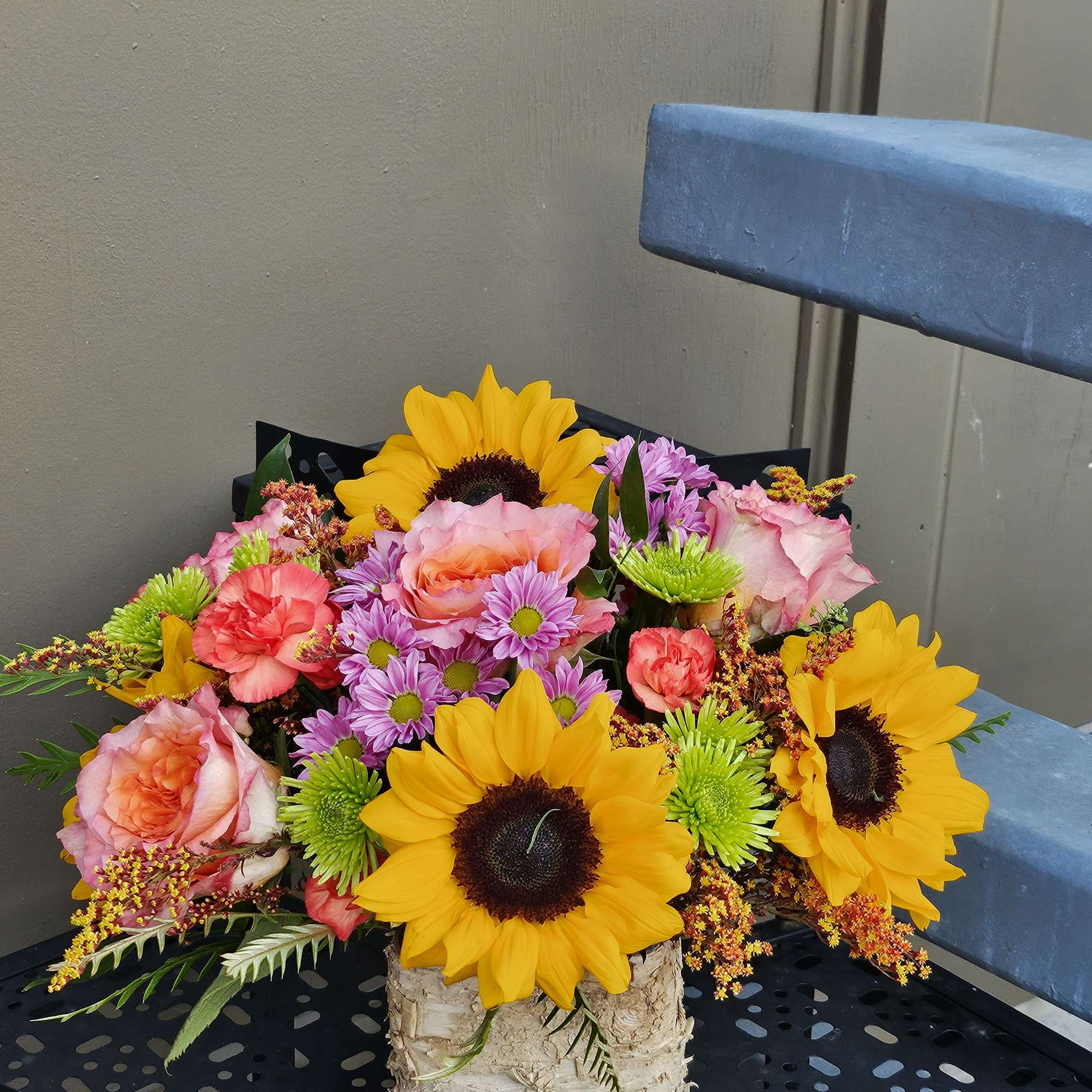 Autumn blooms in a wooden vase. 