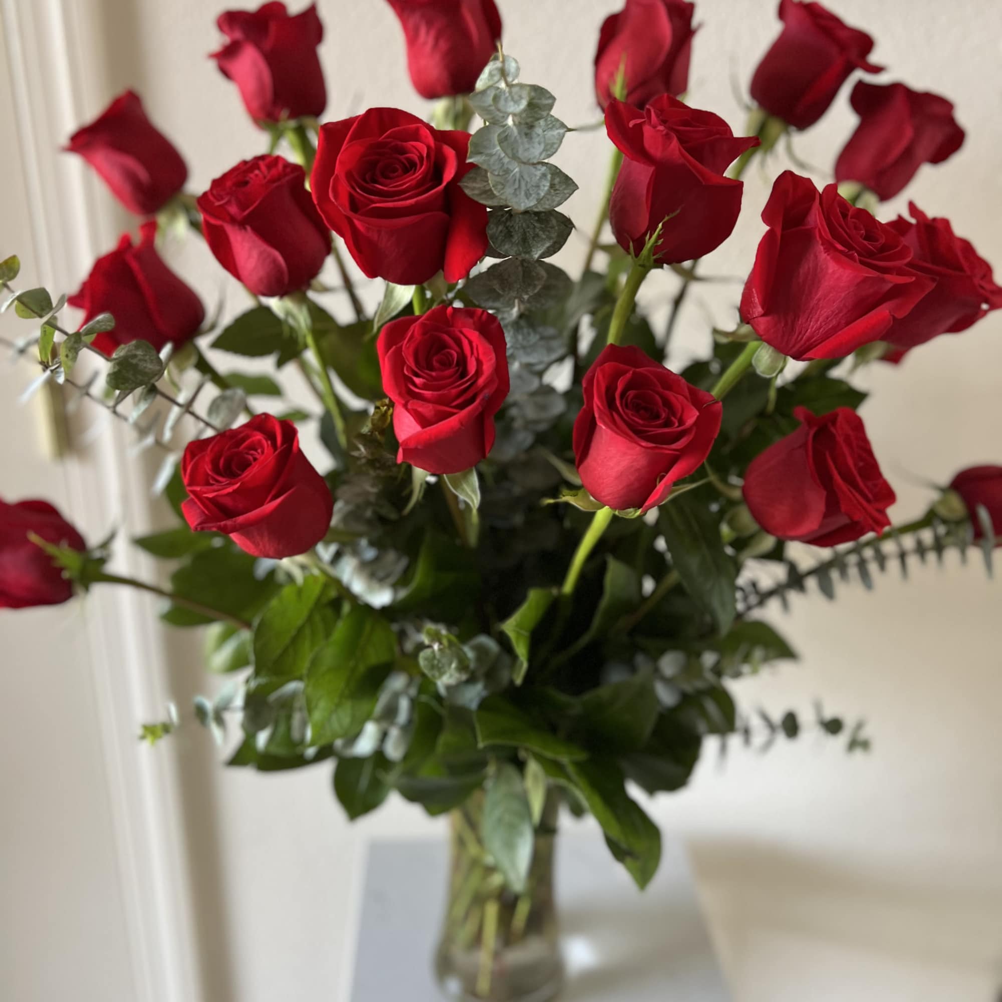 A timeless expression of love and passion, this arrangement features premium red