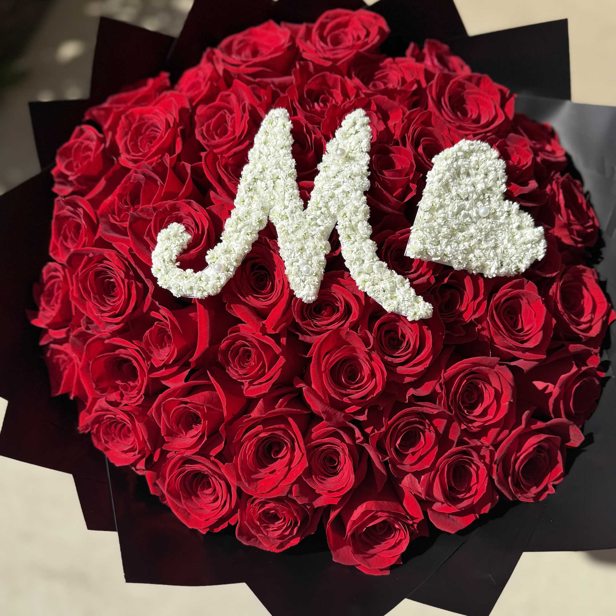 Make a lasting impression with this breathtaking floral arrangement featuring premium red