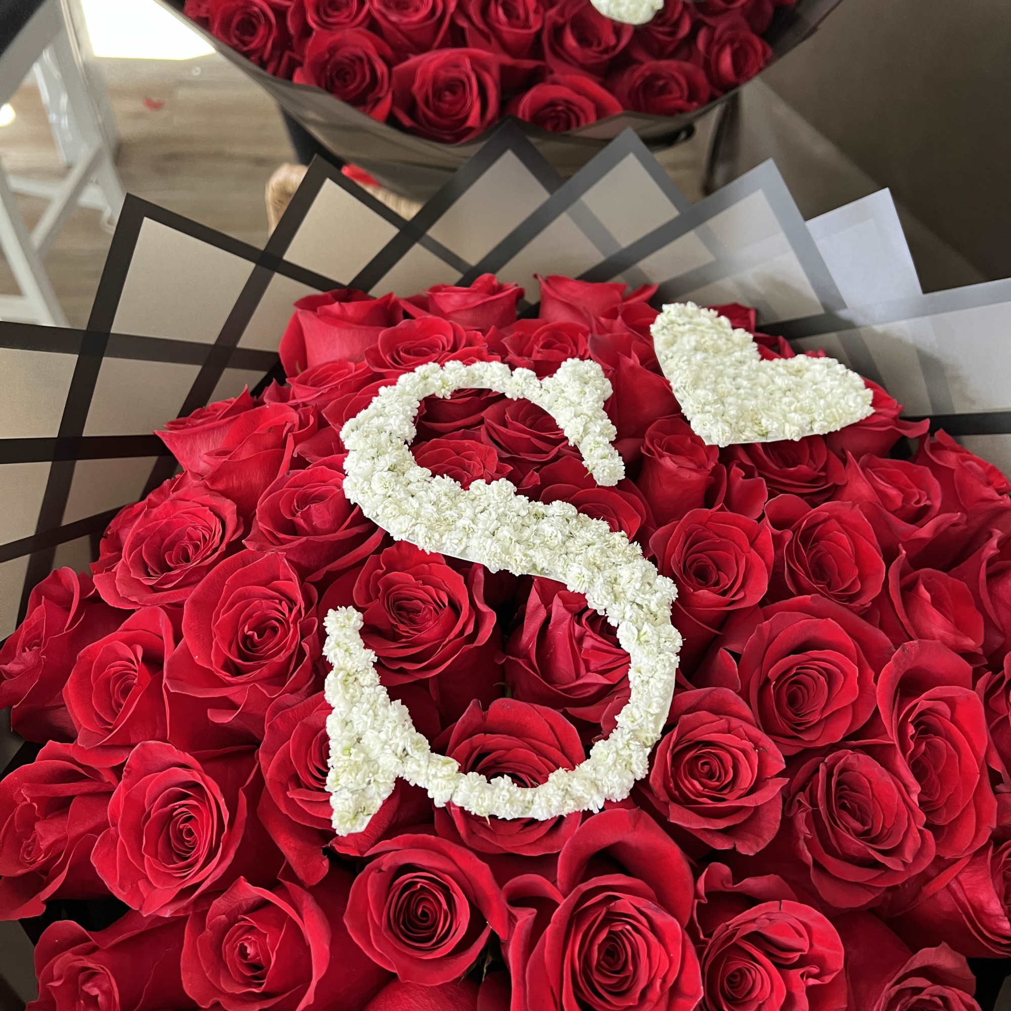 Make a lasting impression with this breathtaking floral arrangement featuring premium red
