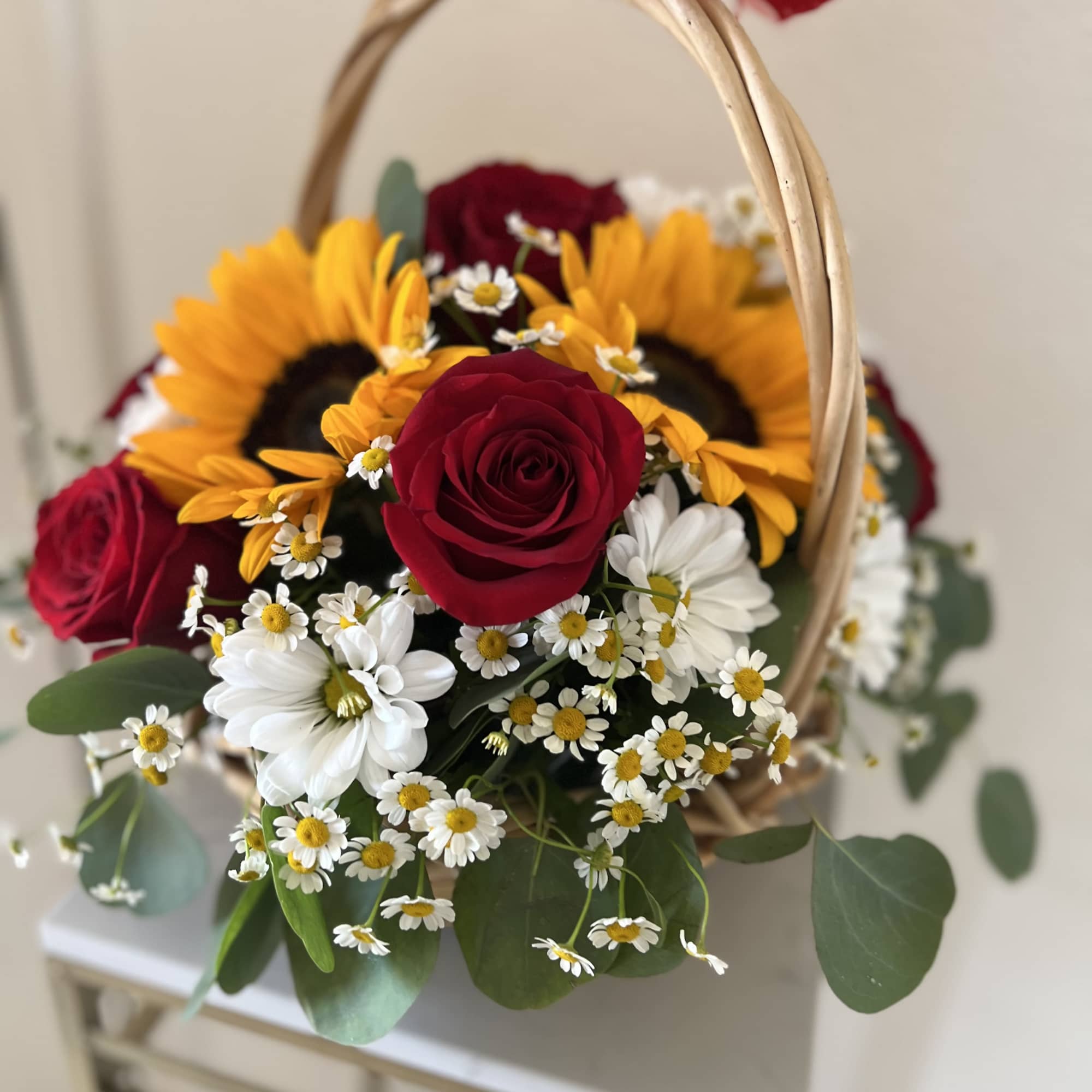 Bring warmth and elegance into any space with this radiant basket arrangement.