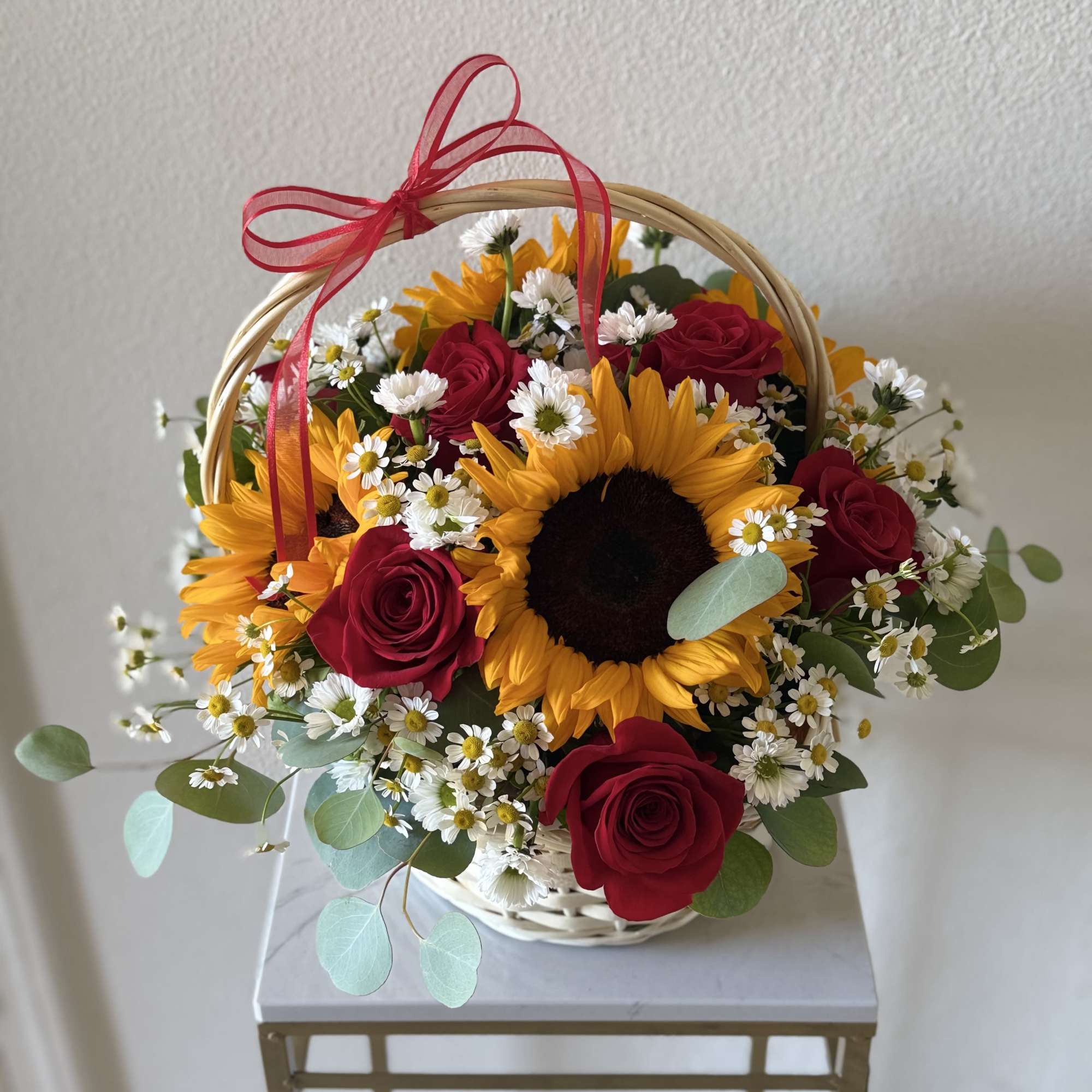Bring warmth and elegance into any space with this radiant basket arrangement.