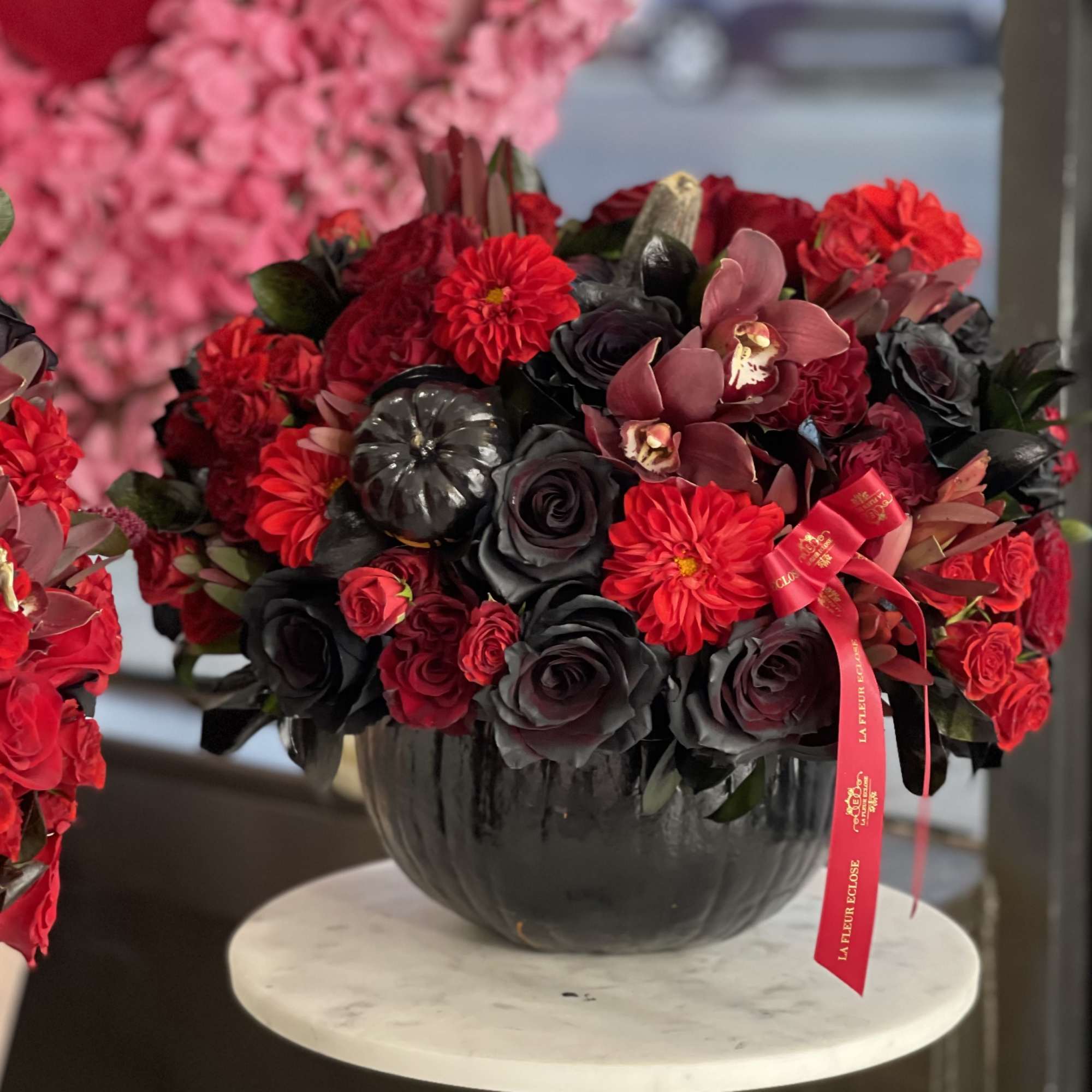 Mix of  red flowers in the  black pumpkin 