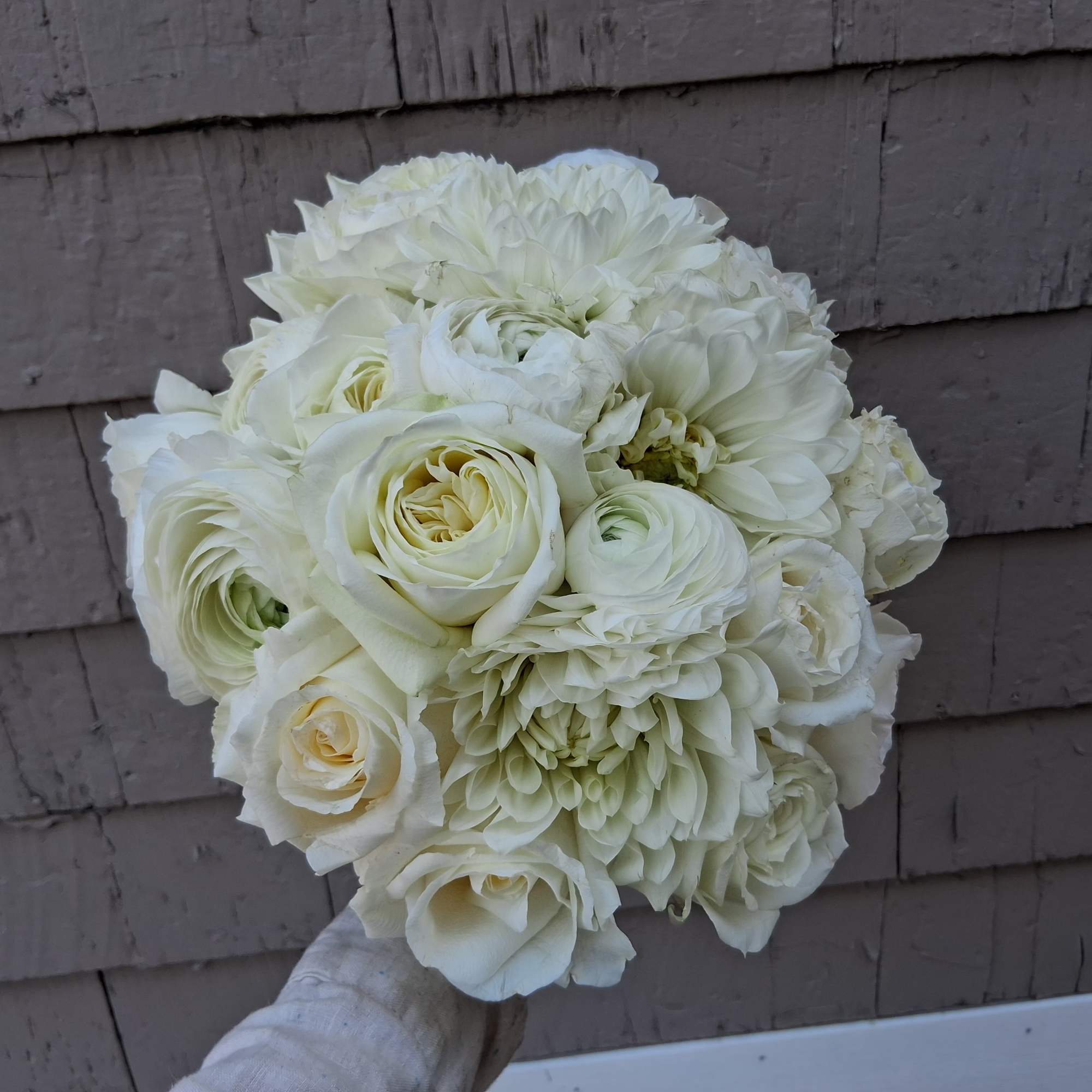 Gorgeous pure white classical round bridal bouquet of standard and garden roses