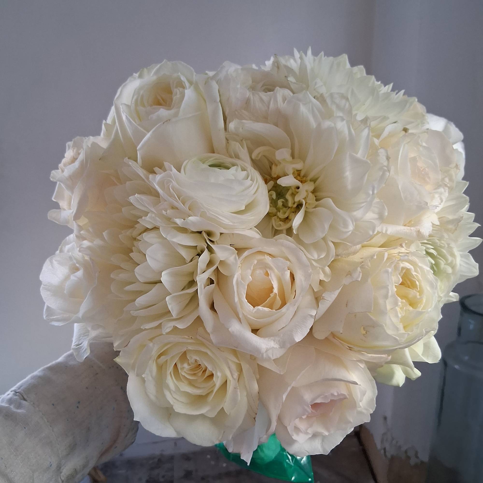 Gorgeous pure white classical round bridal bouquet of standard and garden roses