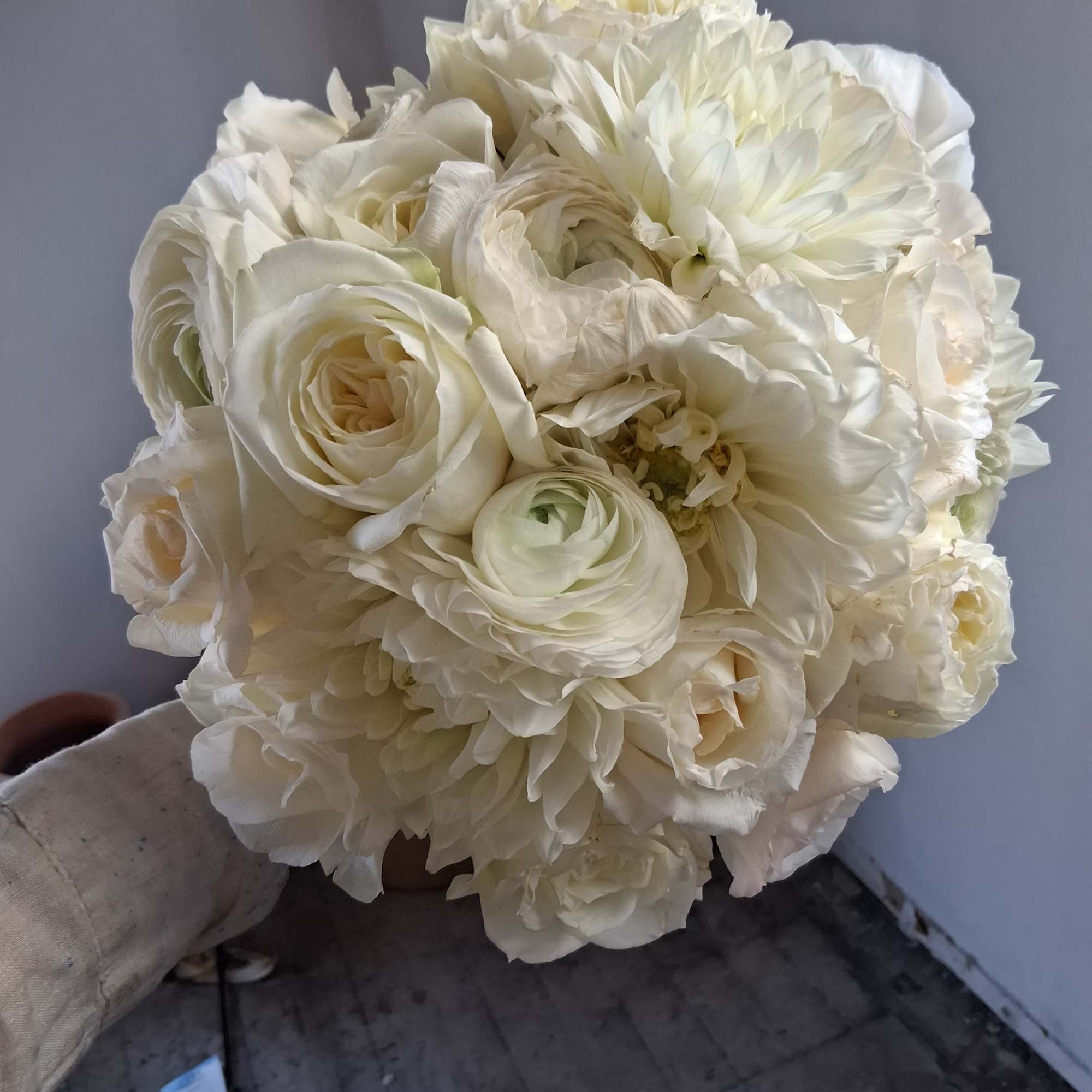 Gorgeous pure white classical round bridal bouquet of standard and garden roses