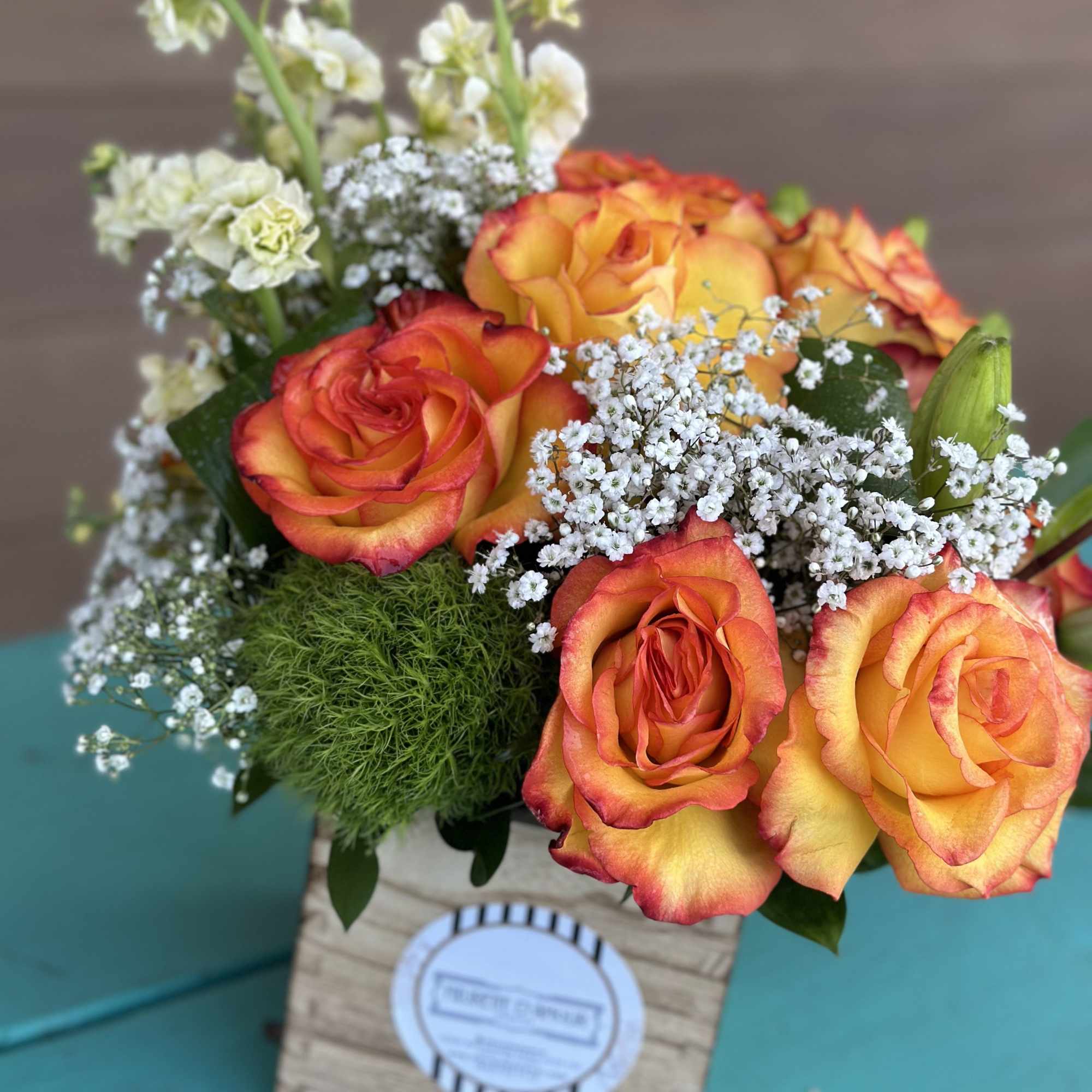 Introducing &quot;Martha,&quot; a charming small wooden box featuring a mix of flowers.