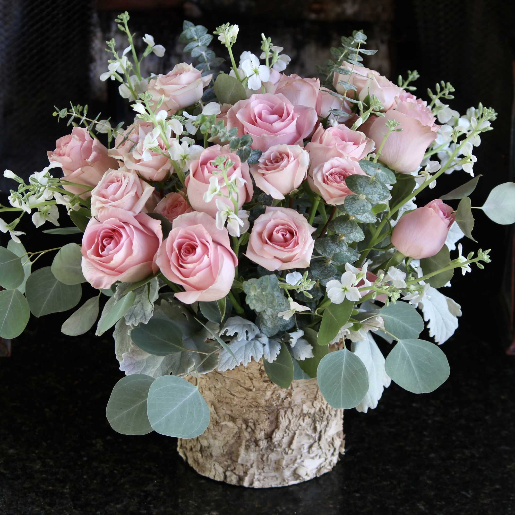 Pink roses and stem roses With small white seasonal flowers and greenery