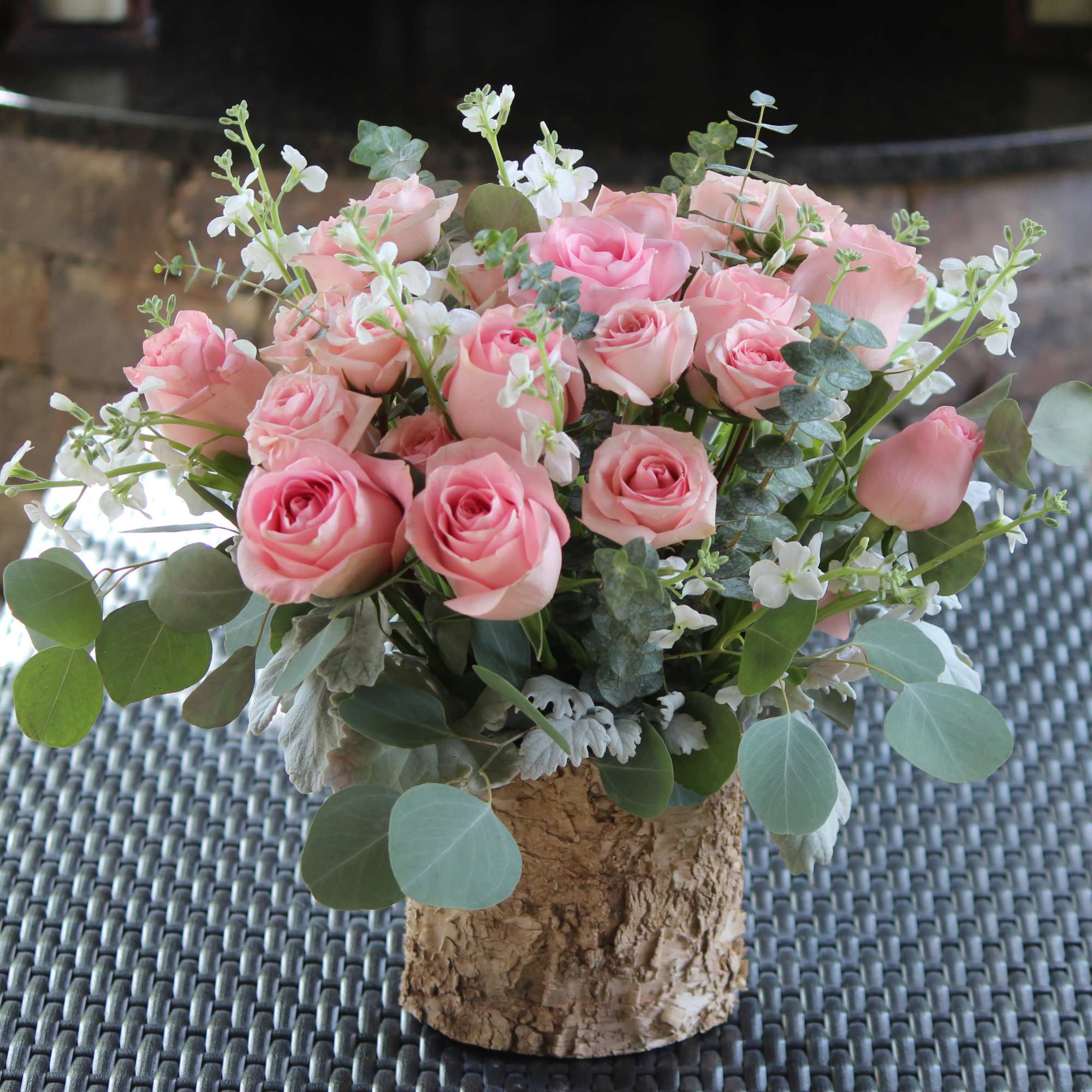 Pink roses and stem roses With small white seasonal flowers and greenery