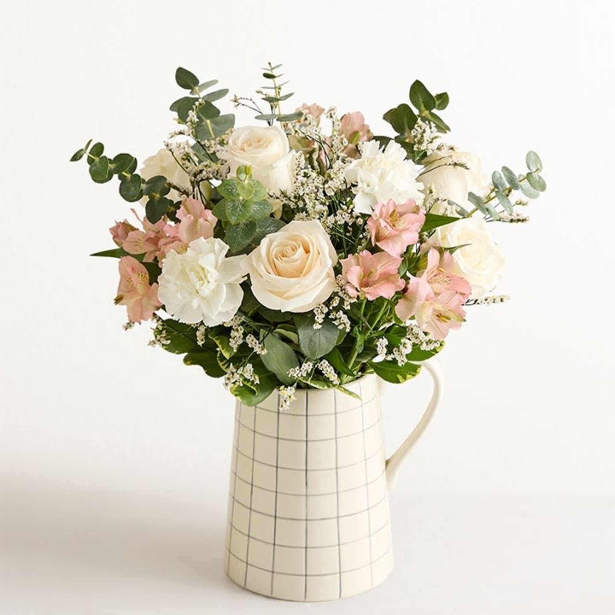 This is a luscious gathering of roses, Peruvian lilies, and other blooms