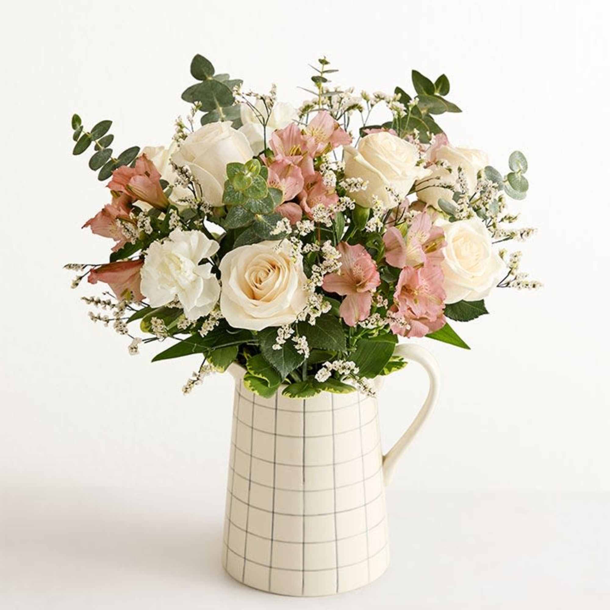 This is a luscious gathering of roses, Peruvian lilies, and other blooms