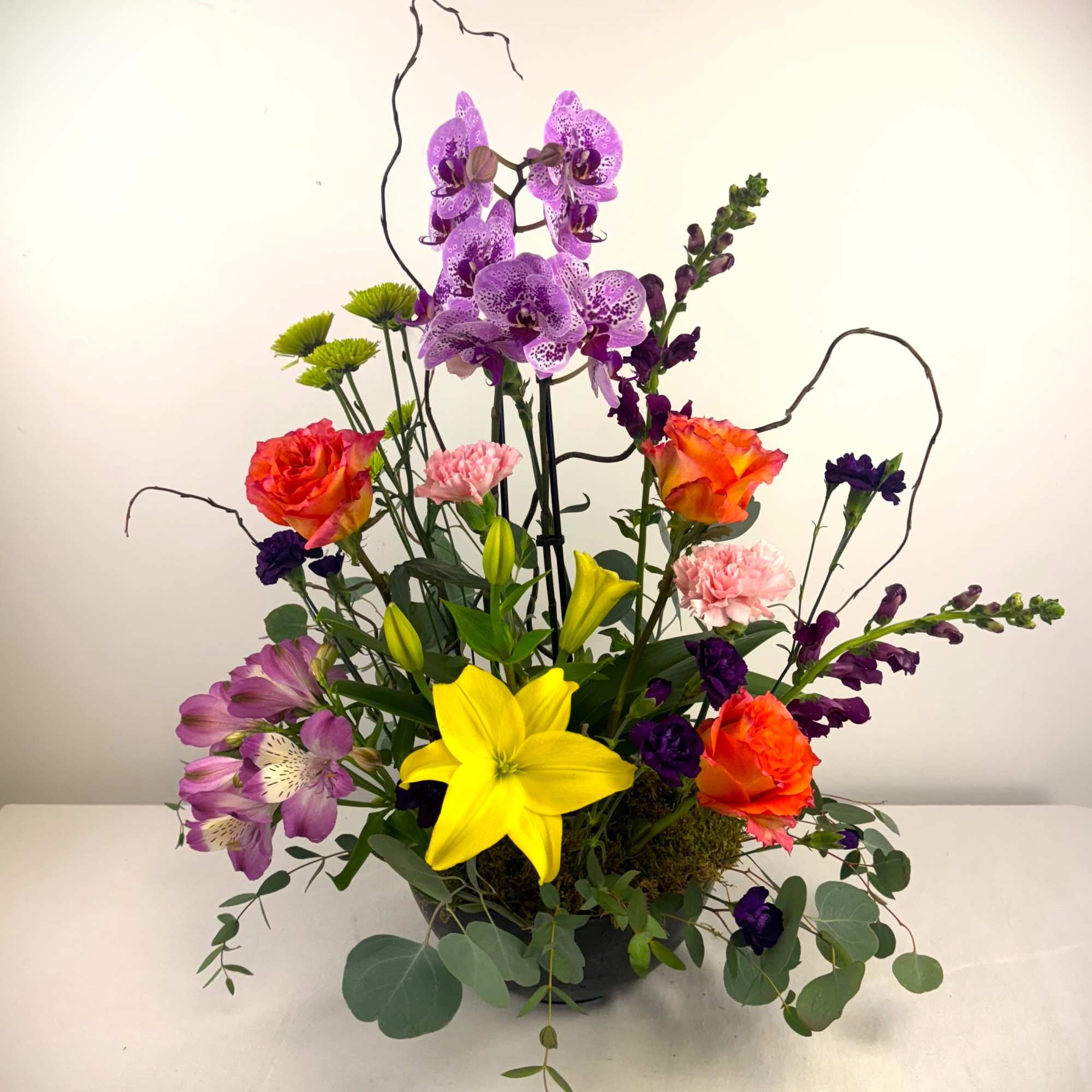 A bright and bold display of beautiful seasonal blooms that includes a