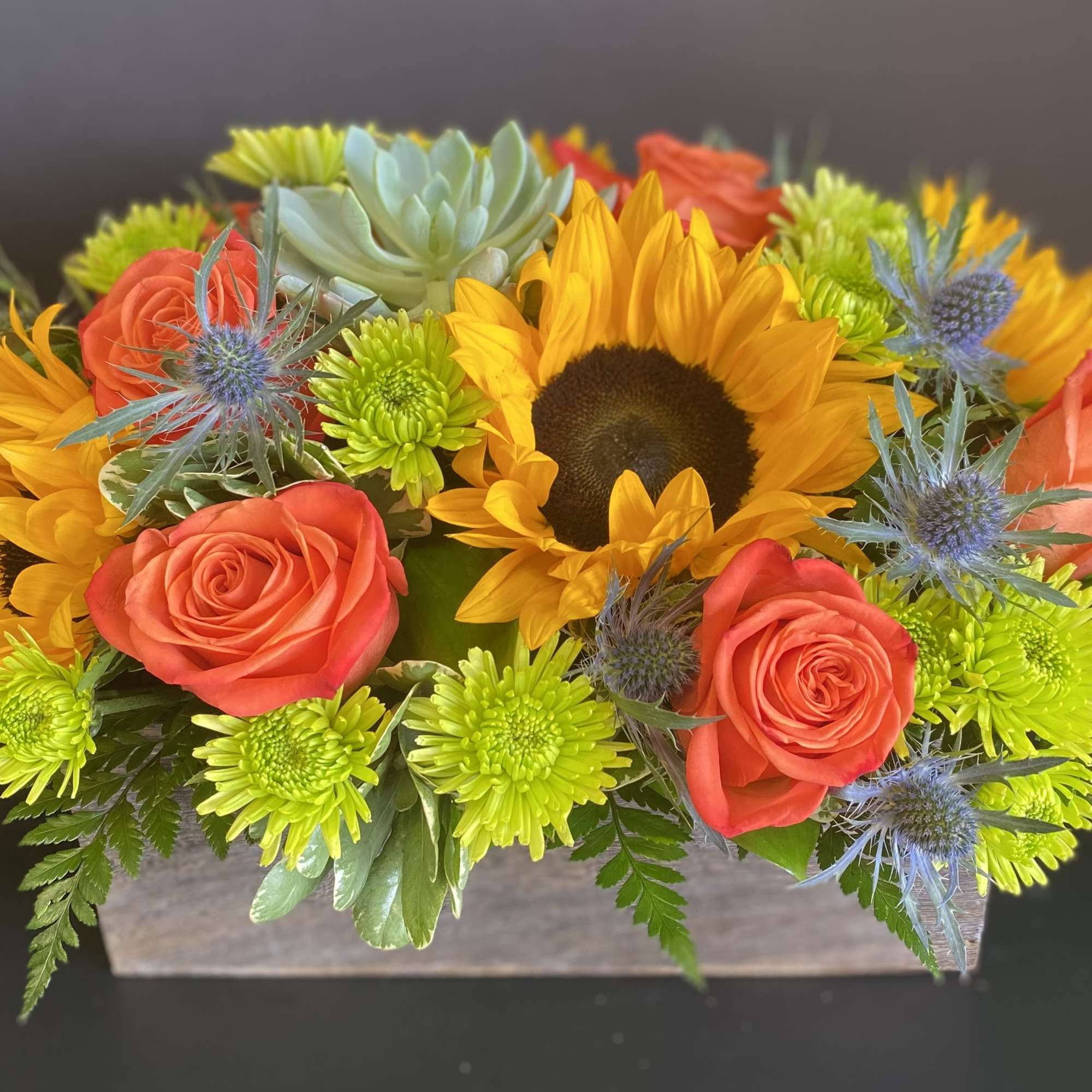 A Bright and Cheerful Low and Lush Centerpiece in a Wooden Box.