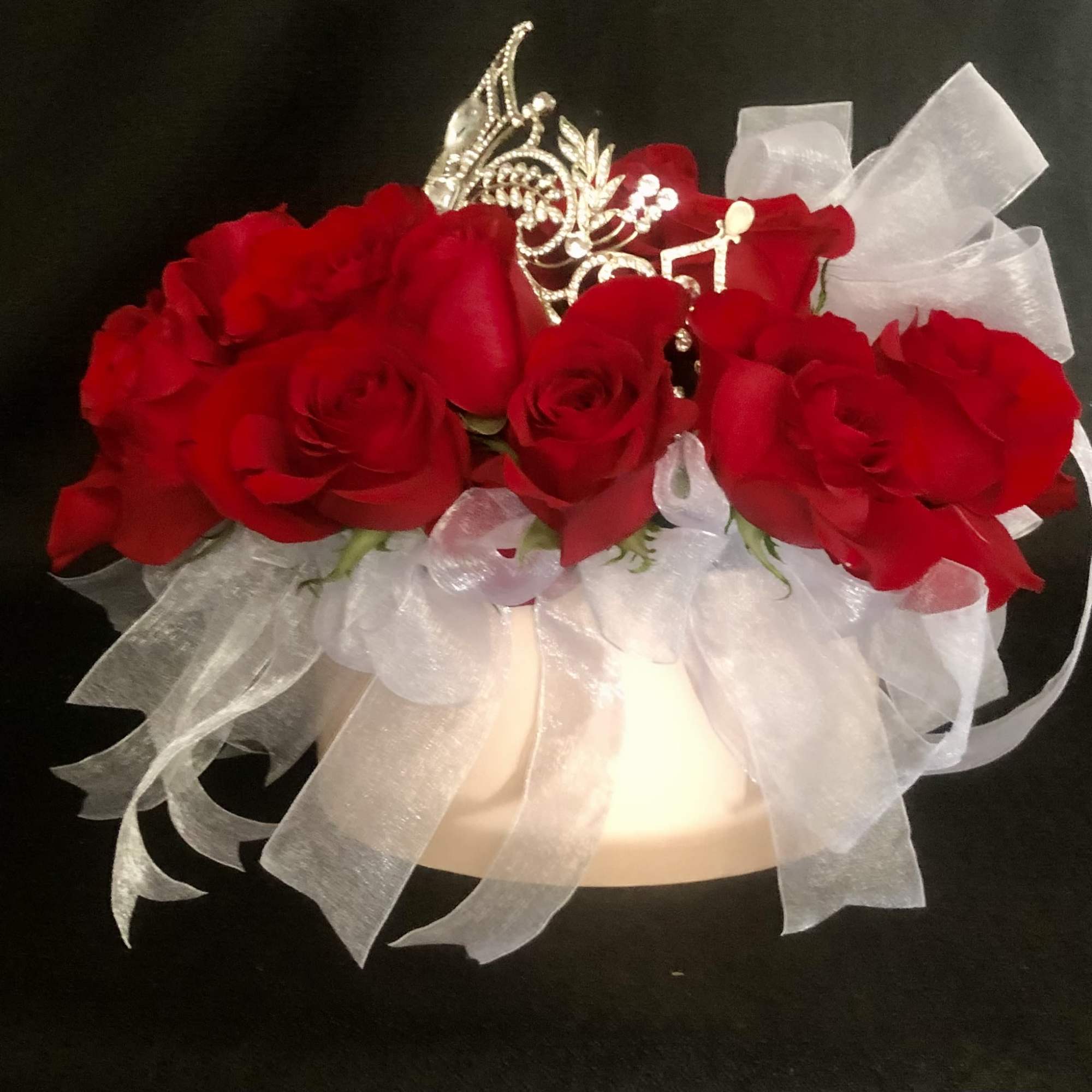 24 RED ROSES WITH RIBBON TIED TO THE OUTER STEMS, IN A