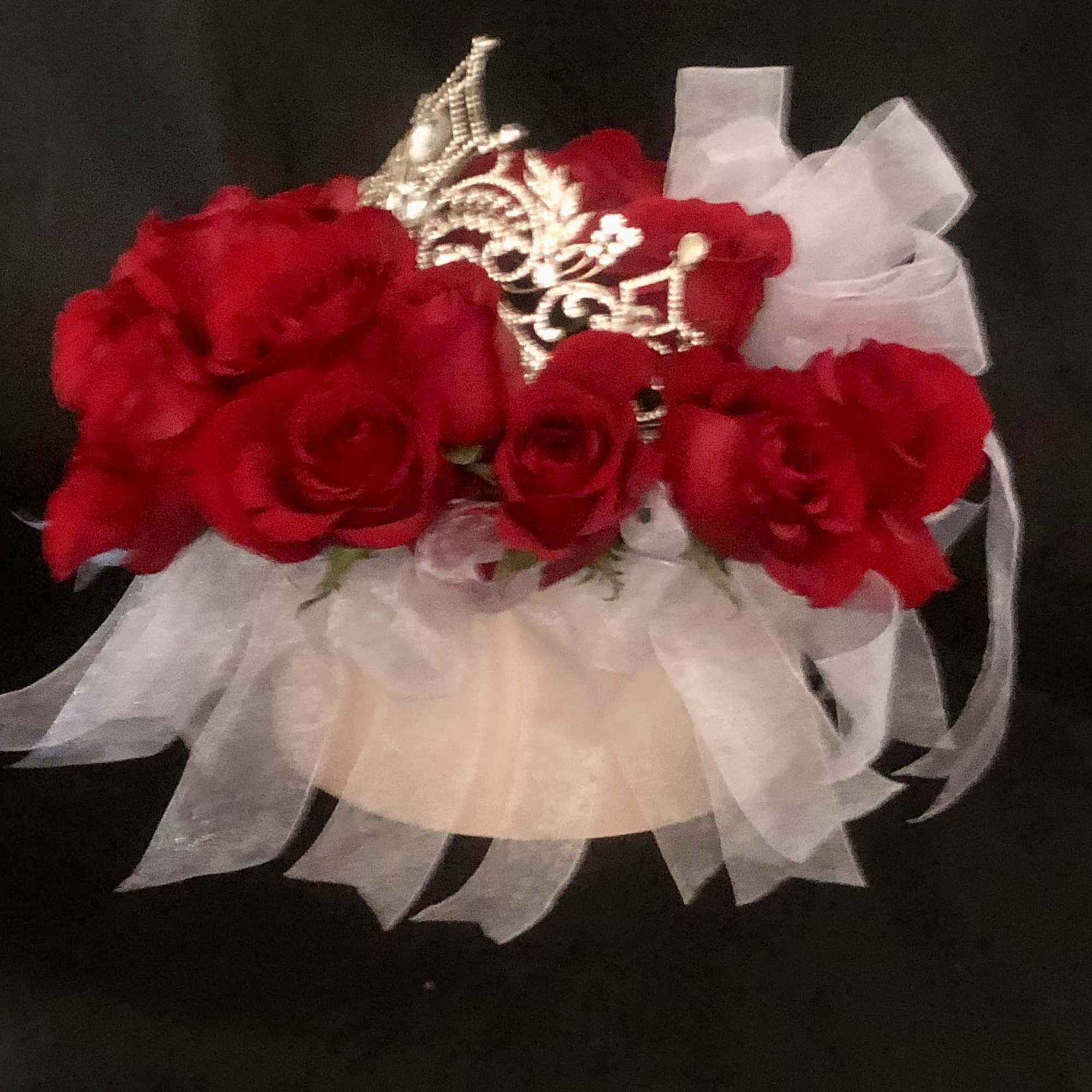 24 RED ROSES WITH RIBBON TIED TO THE OUTER STEMS, IN A