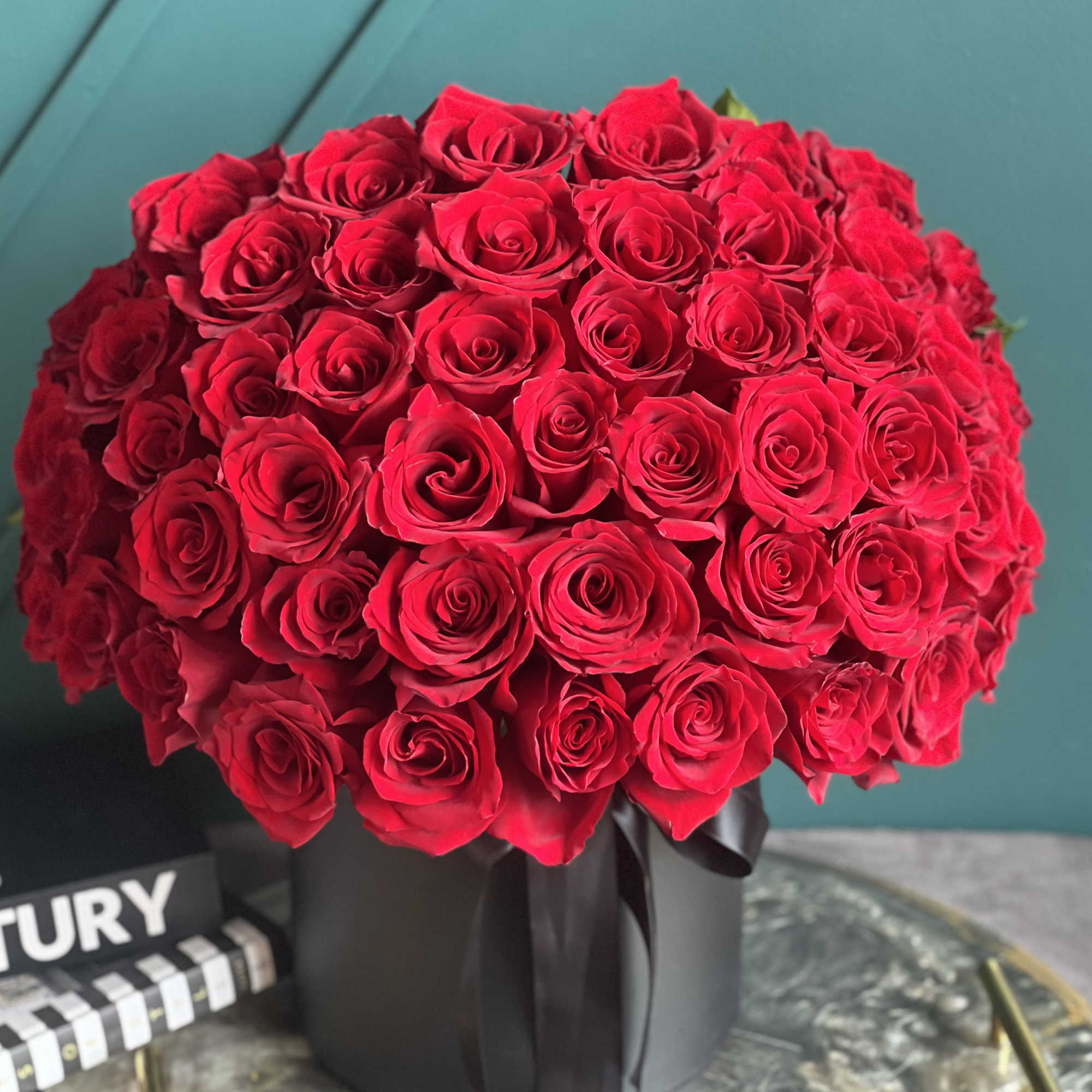 50 red roses in a box with lid on the back 