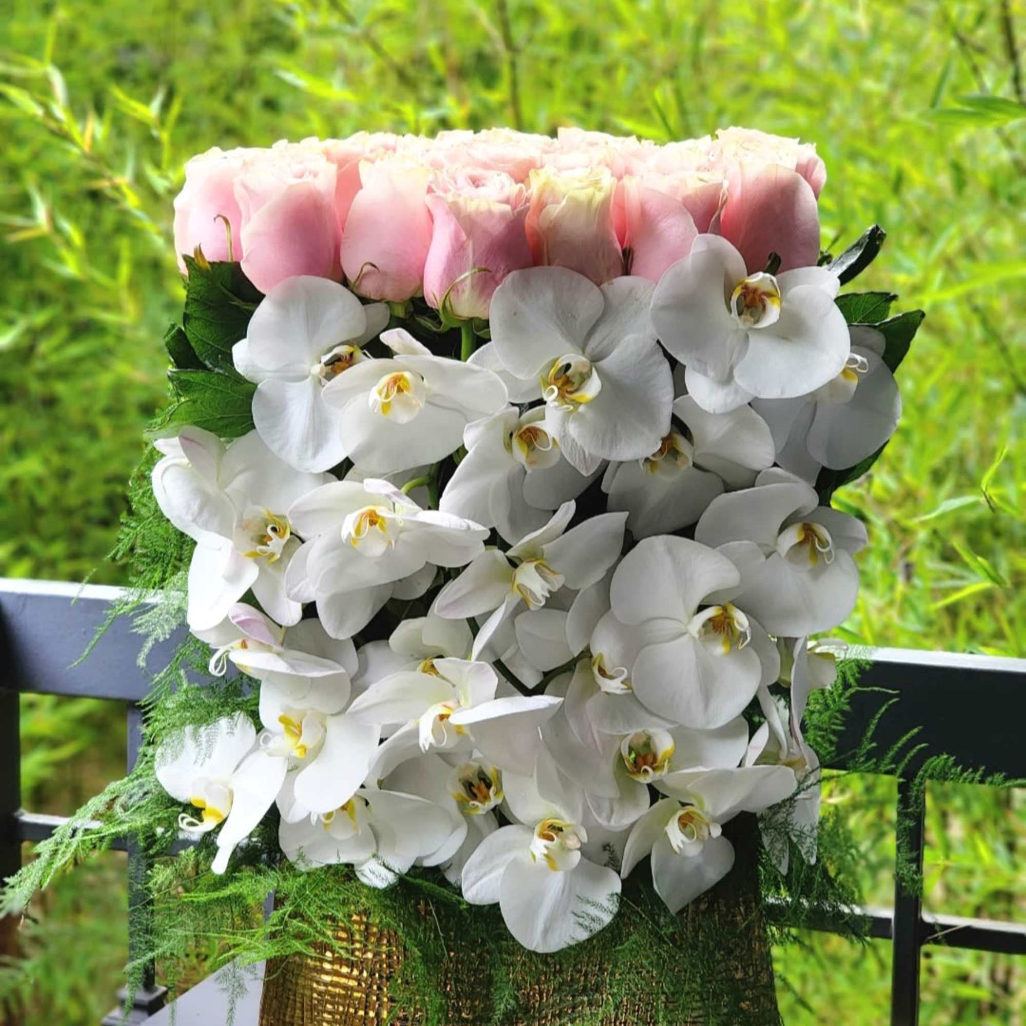 This luxurious arrangement combines the soft beauty of blush pink roses with