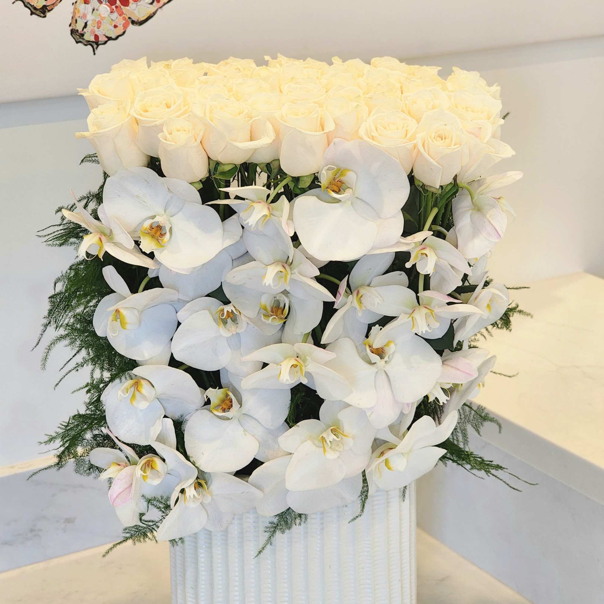 This luxurious arrangement combines the soft beauty of blush pink roses with