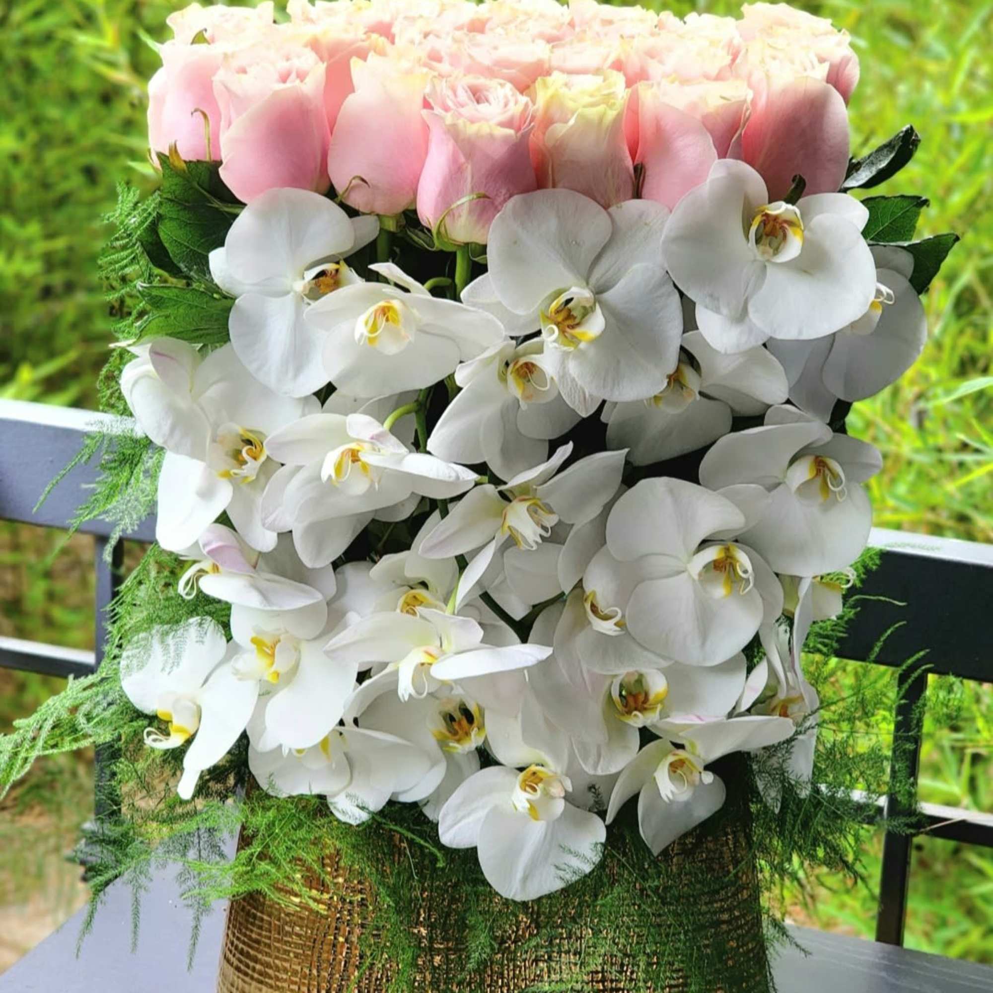 This luxurious arrangement combines the soft beauty of blush pink roses with