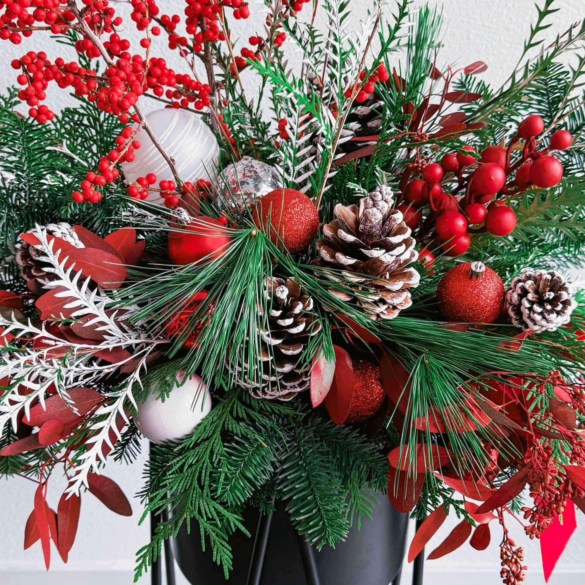 This breathtaking Christmas bouquet captures the essence of winter festivities with its This breathtaking Christmas bouquet captures the essence of winter festivities with its