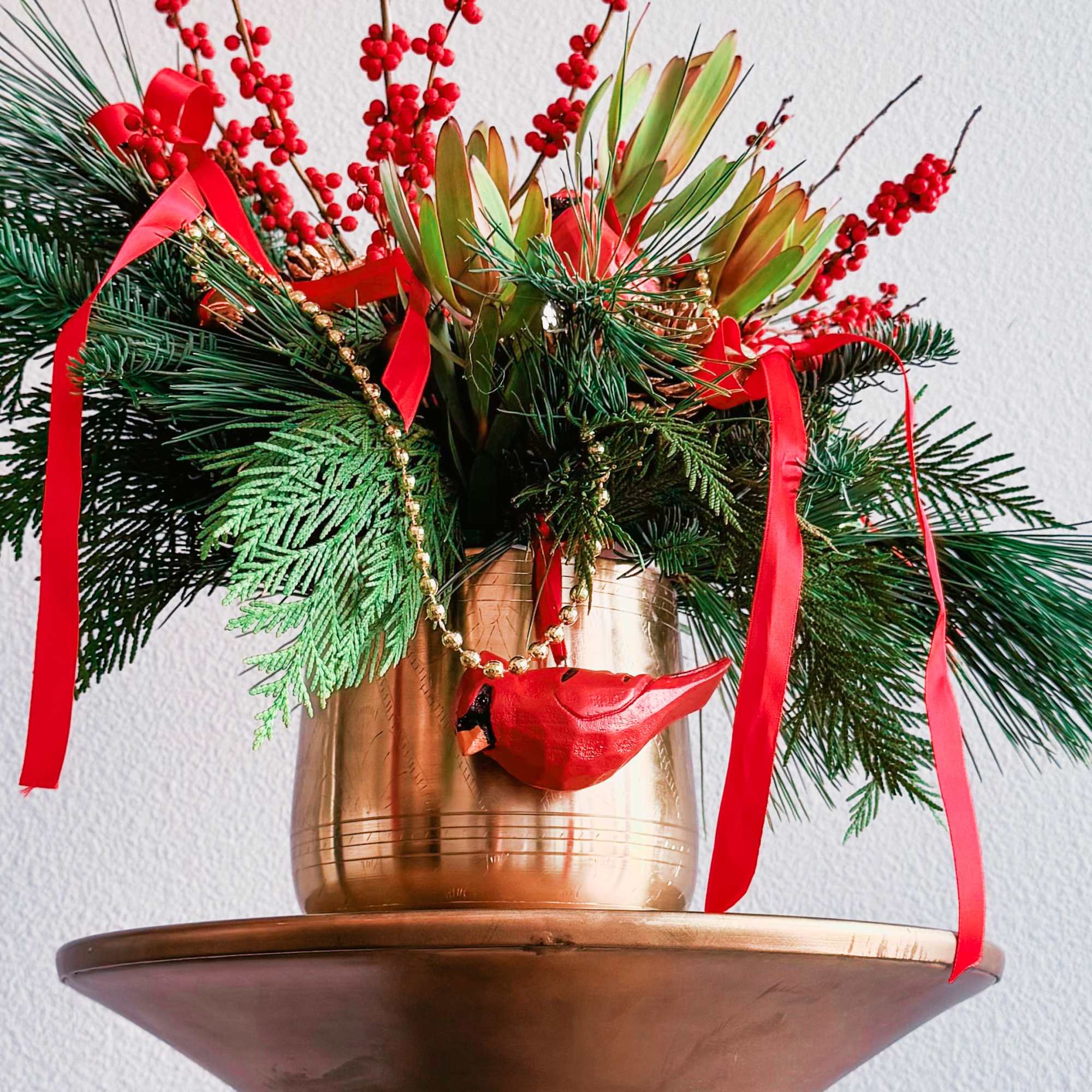This Christmas bouquet radiates festive warmth and charm, combining vibrant red and This Christmas bouquet radiates festive warmth and charm, combining vibrant red and