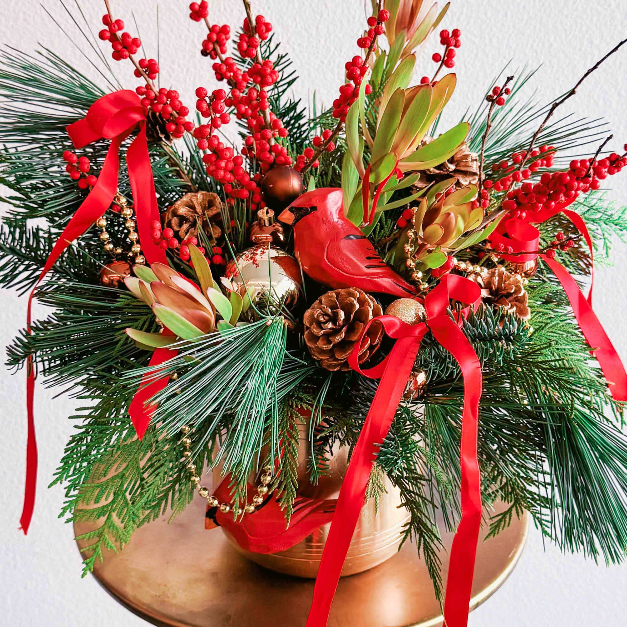 This Christmas bouquet radiates festive warmth and charm, combining vibrant red and This Christmas bouquet radiates festive warmth and charm, combining vibrant red and