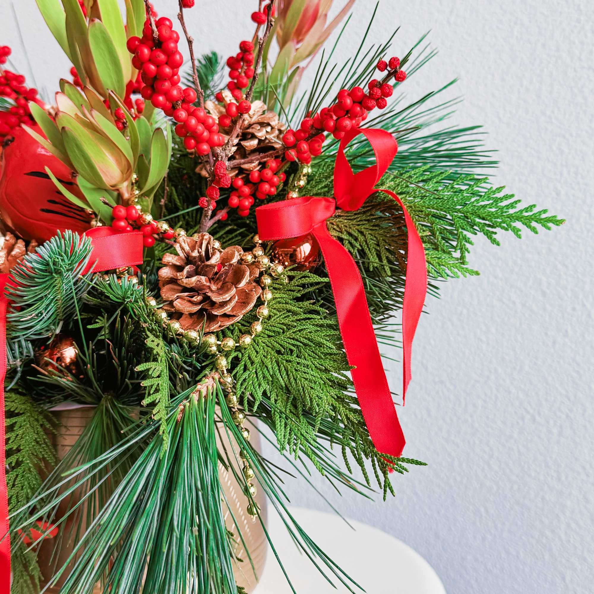 This Christmas bouquet radiates festive warmth and charm, combining vibrant red and This Christmas bouquet radiates festive warmth and charm, combining vibrant red and