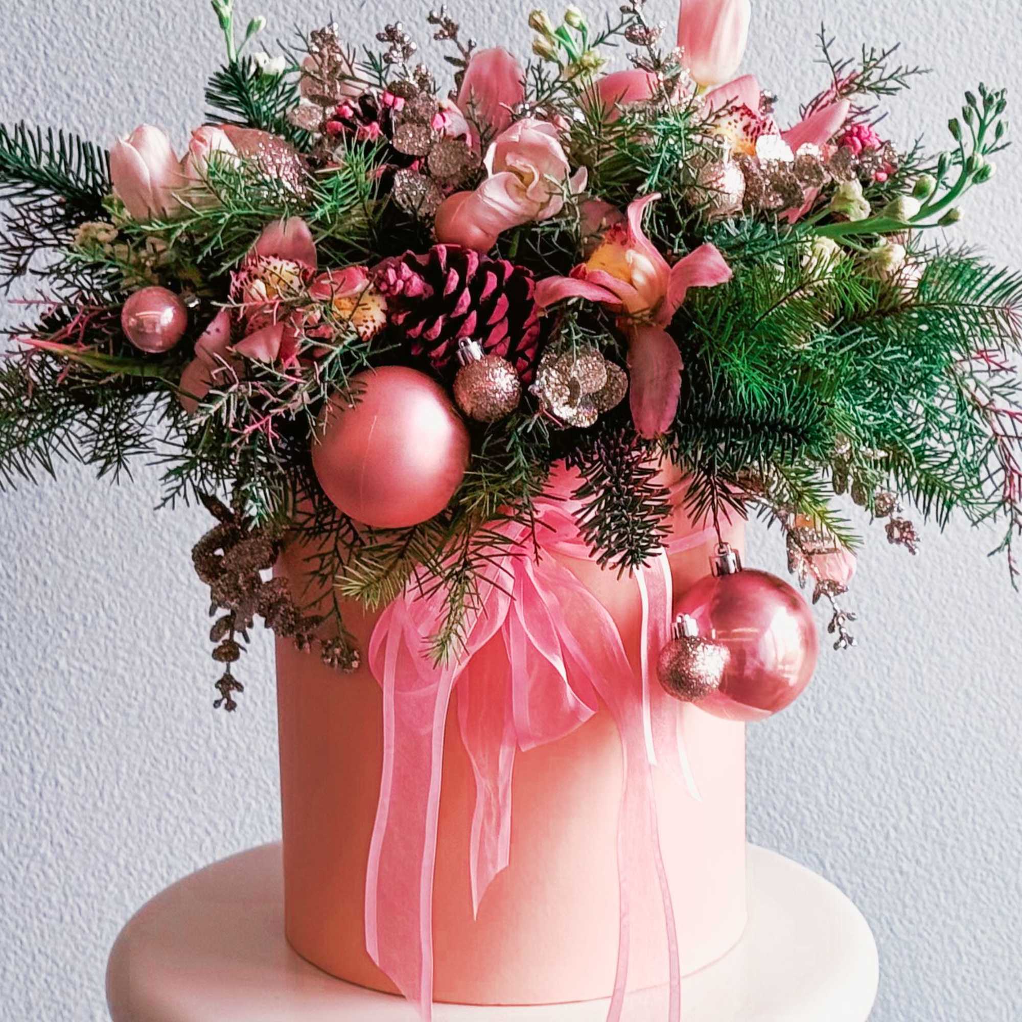 This Christmas arrangement is a festive and elegant centerpiece designed to bring This Christmas arrangement is a festive and elegant centerpiece designed to bring