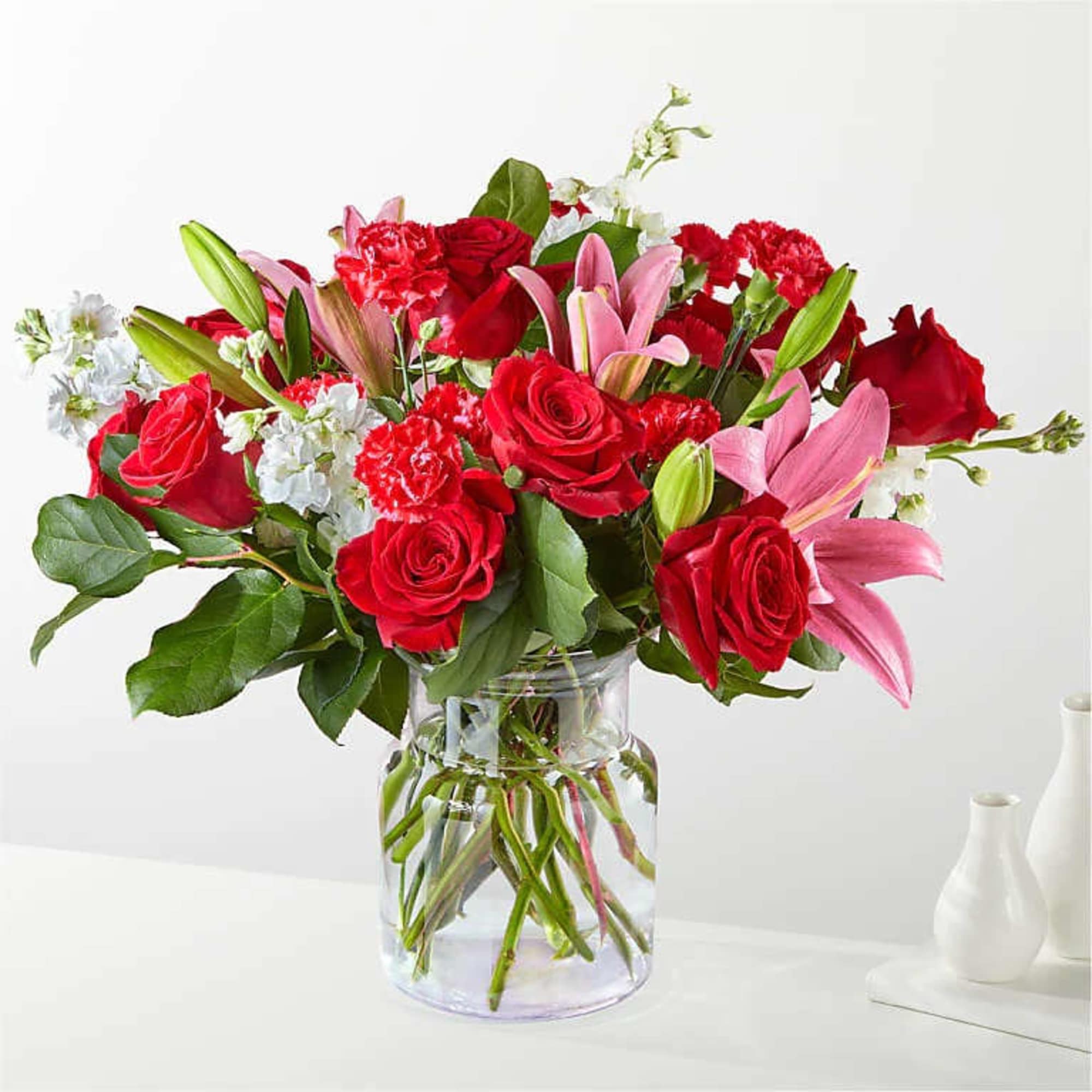 With an abundant blend of roses, carnations, and LA Hybrid lilies in