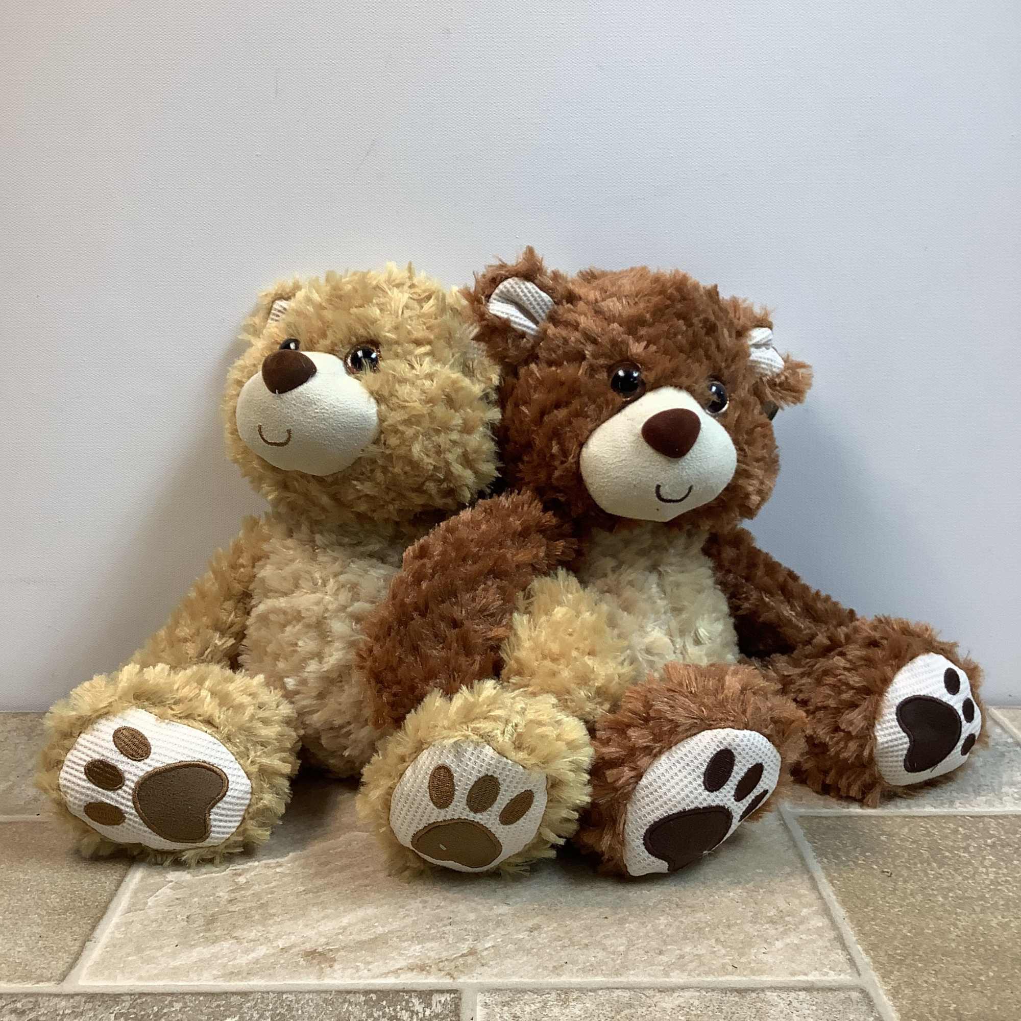 Willoughby is a very soft, tan-colored plush bear with a happy face.