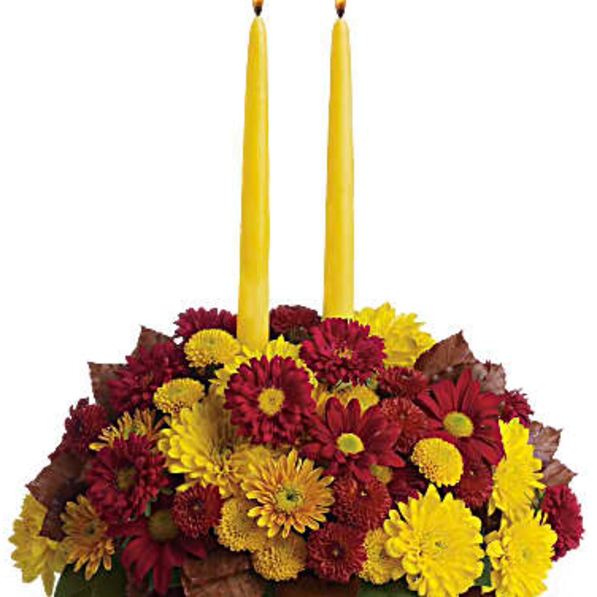 Happy yellow mums and a golden taper candle bring sunshine to your