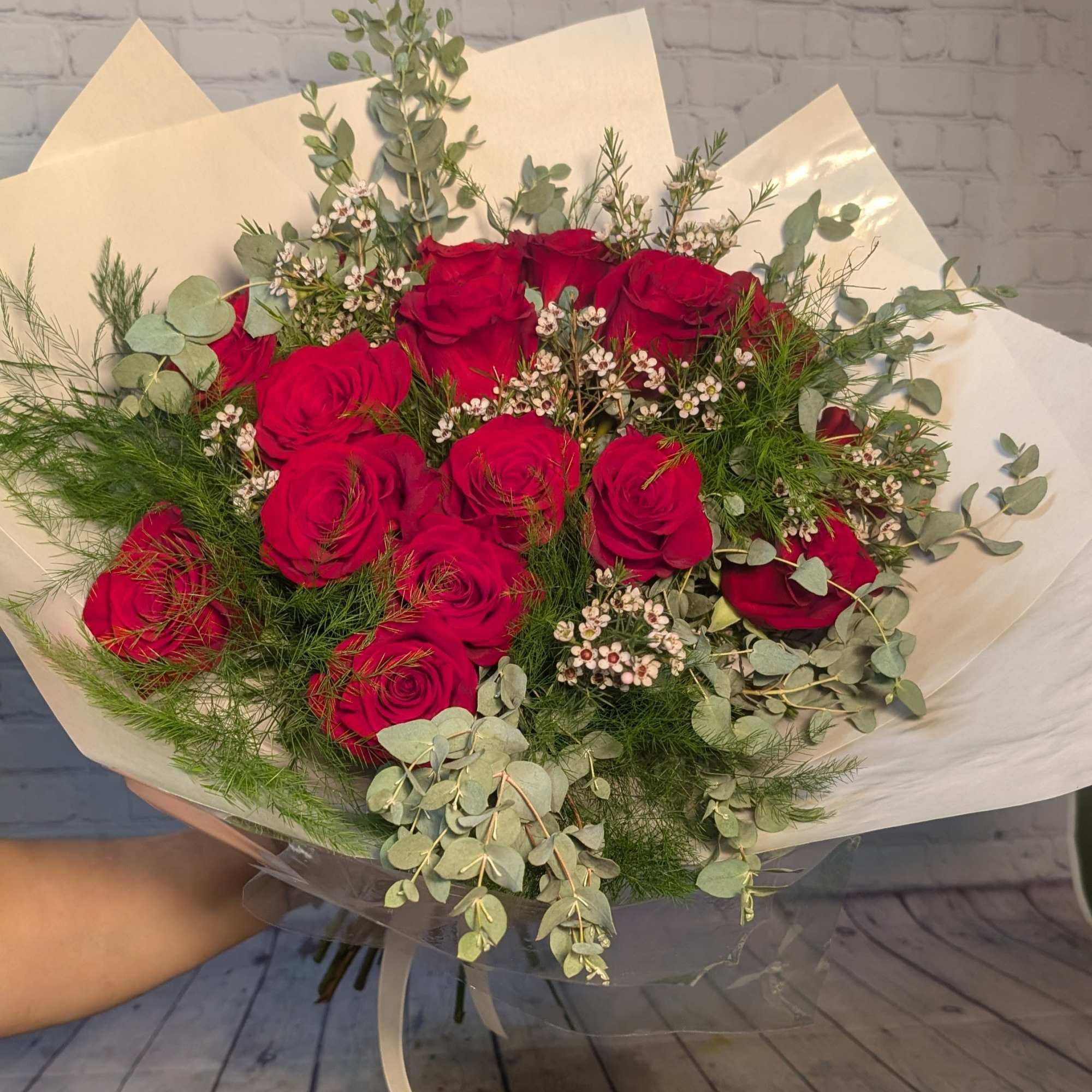 A hand-tied 1/2 dozen red rose bouquet mixed with gunny eucalyptus and A hand-tied 1/2 dozen red rose bouquet mixed with gunny eucalyptus and