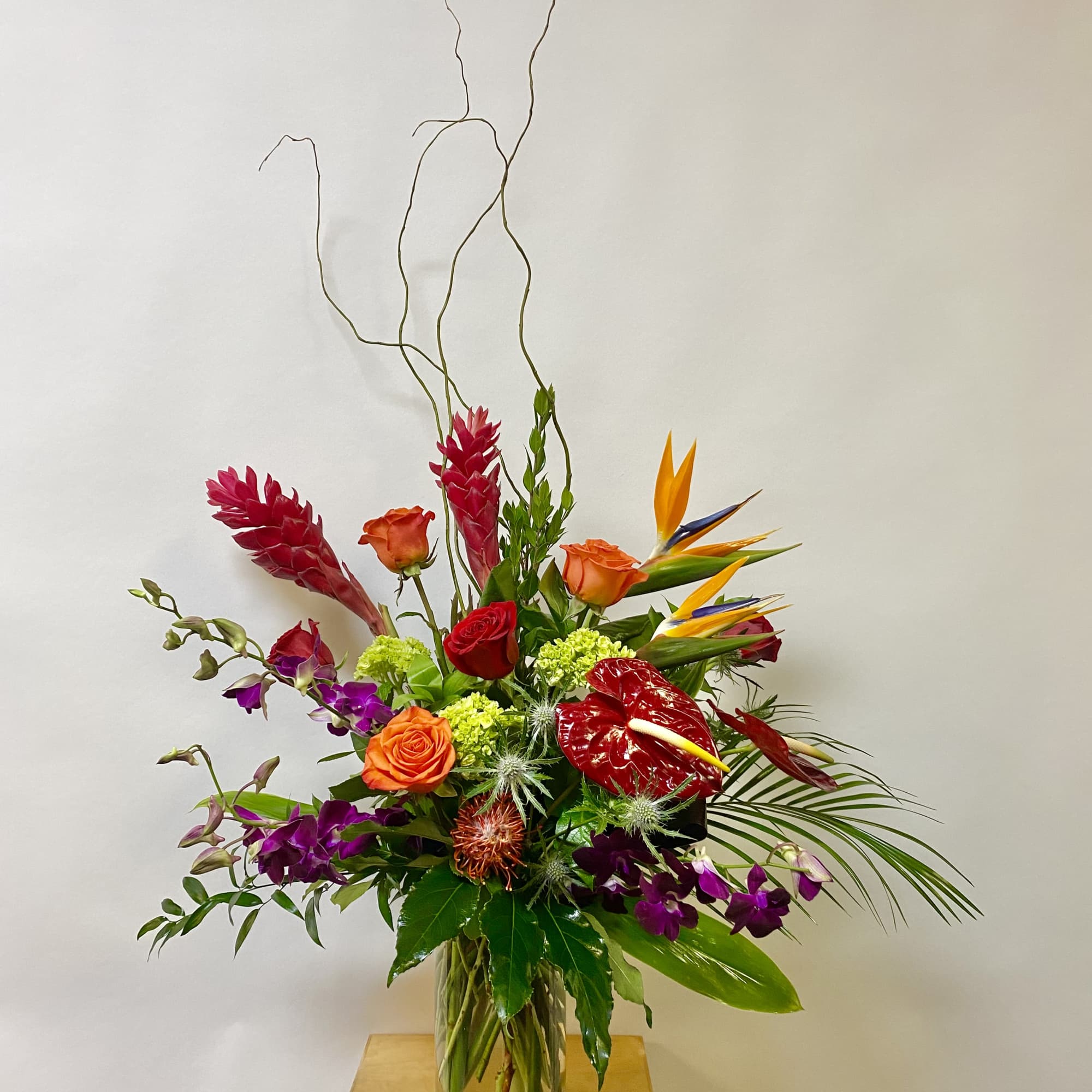 This Tall Tropical Arrangement includes Birds of Paradise, Red Ginger, Red Anthurium