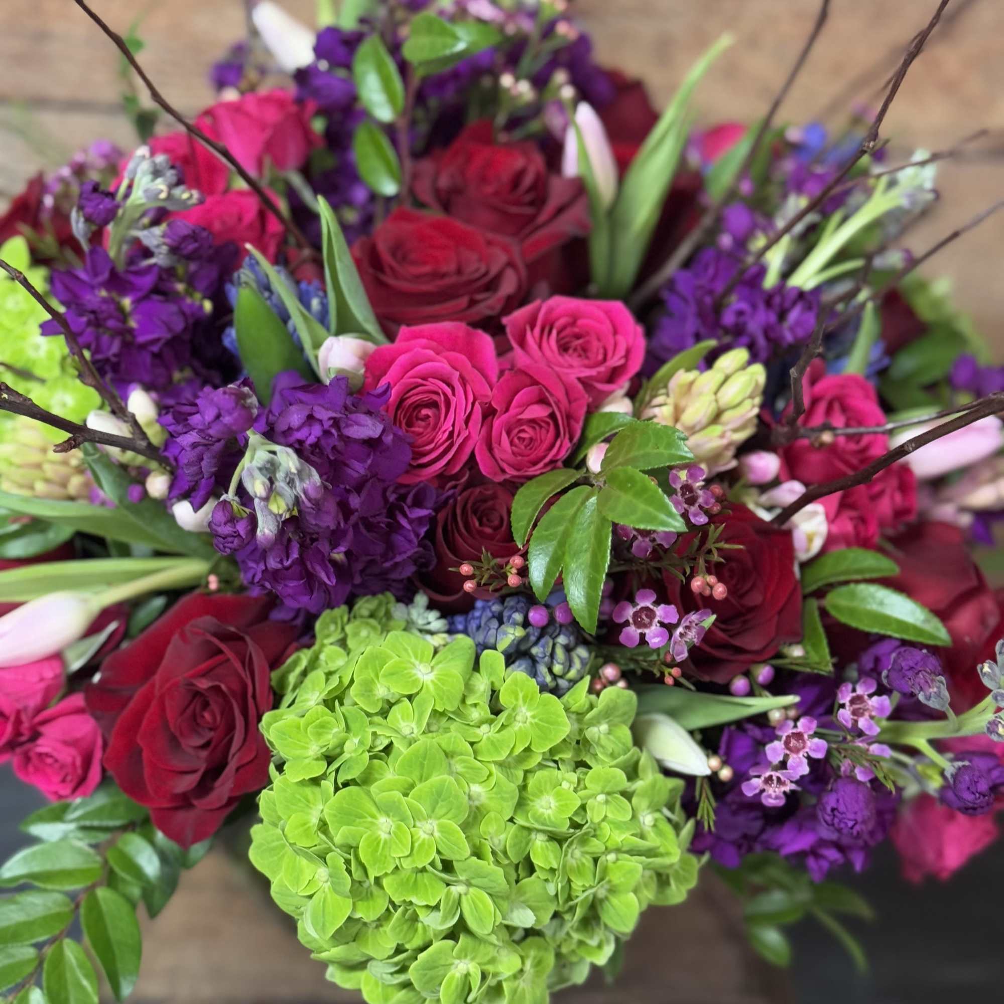 A beautiful arrangement in vibrant colors and a variety of flowers including A beautiful arrangement in vibrant colors and a variety of flowers including