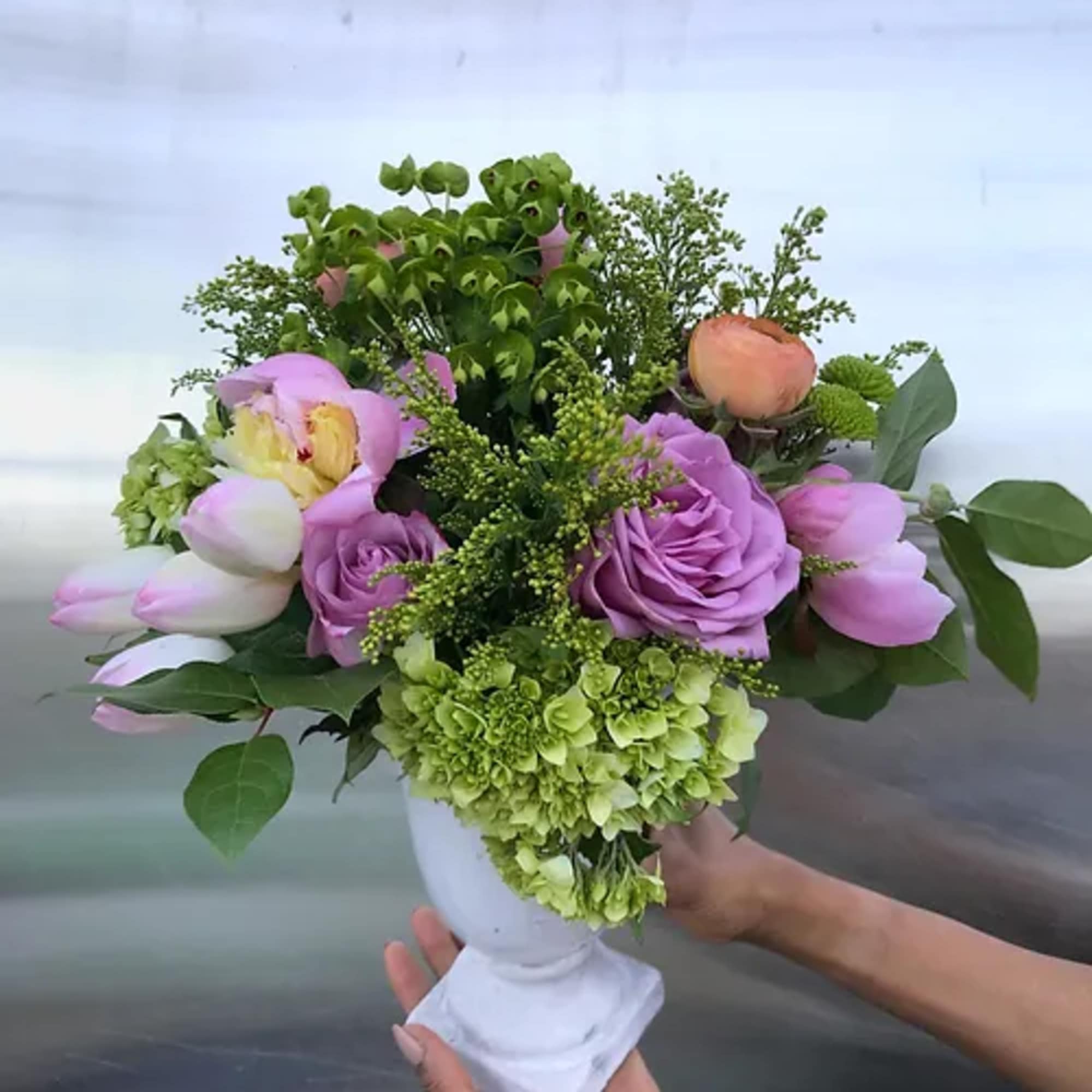 A an overflowing bouquet of local and seasonal blooms in our signature
