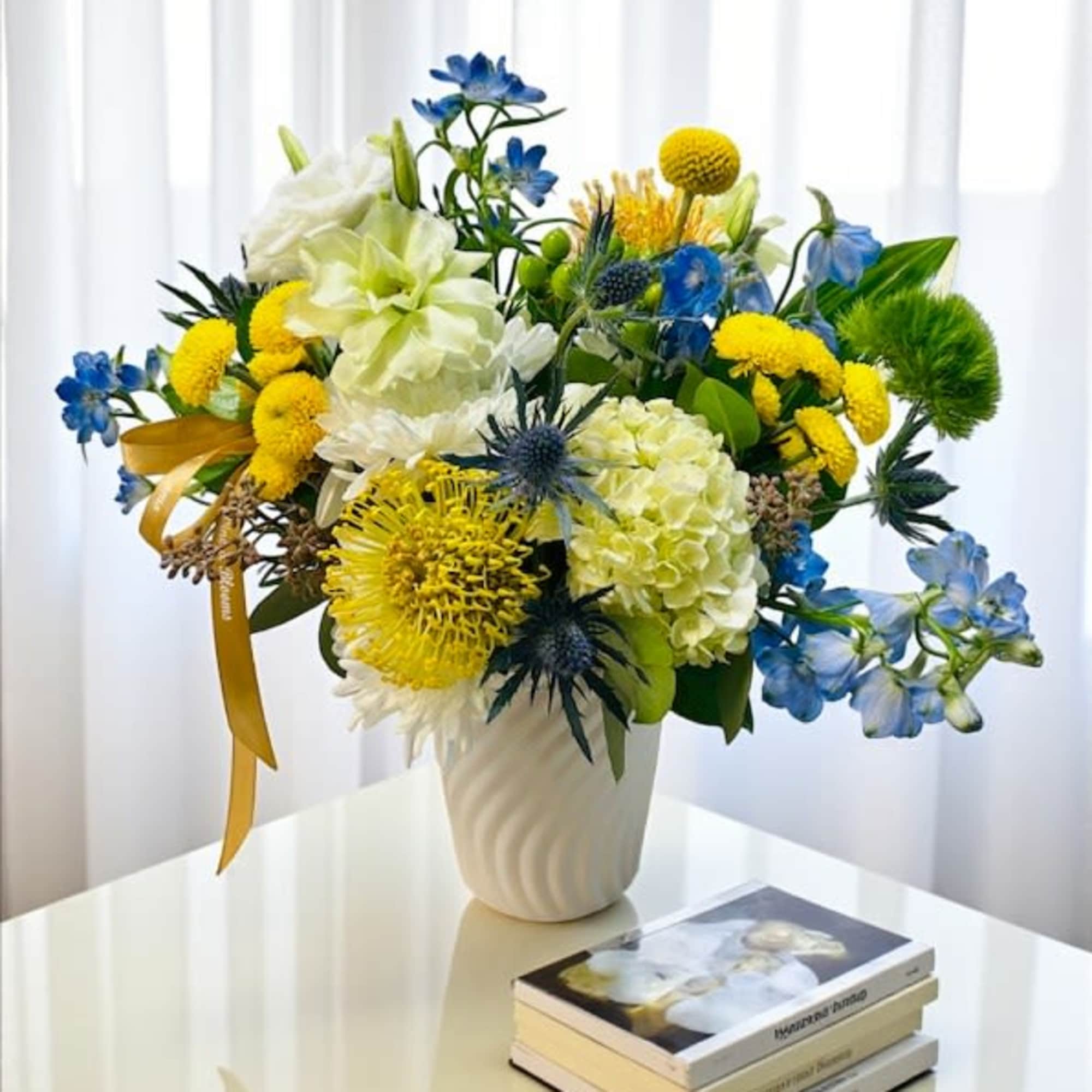 A modern blend of white, yellow, and blue blooms &mdash; effortlessly elegant