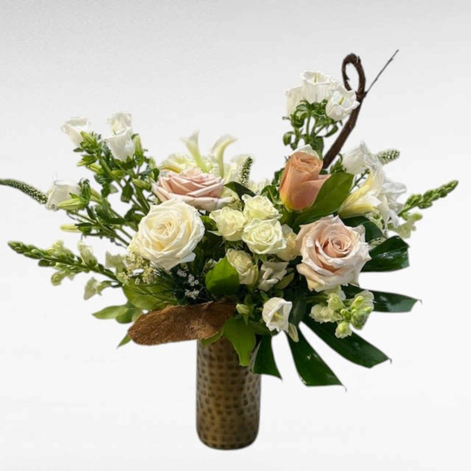 An elegant tall arrangement that blends soft blush and dusty tones with