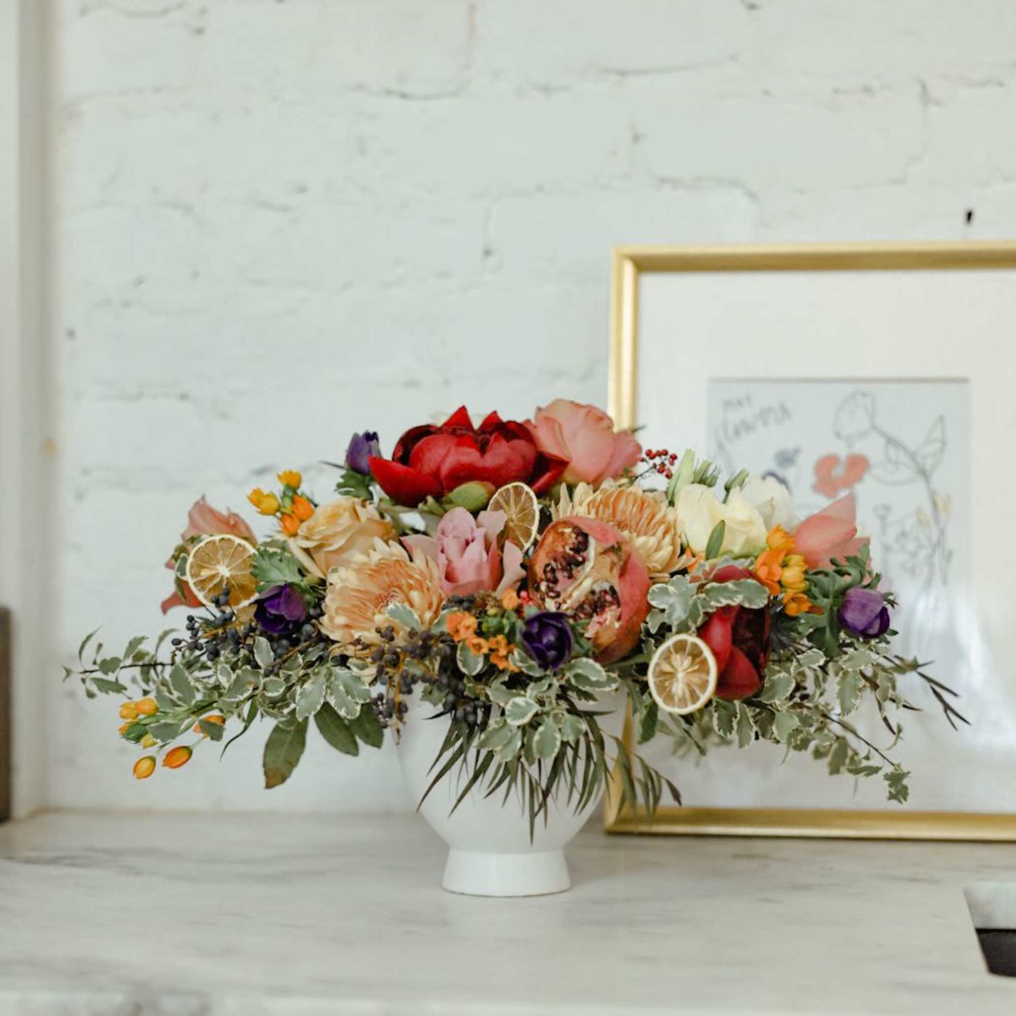A lush and unique arrangement with berries, dried fruit, garden roses, muted A lush and unique arrangement with berries, dried fruit, garden roses, muted