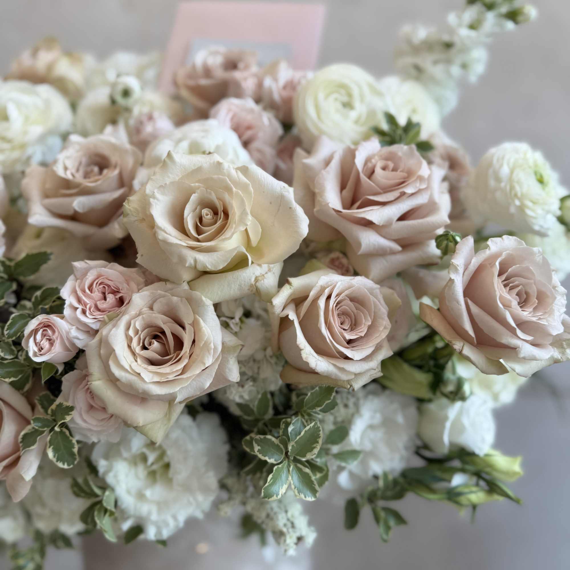 This arrangement features elegant beige nude Quicksand roses with lush garden roses