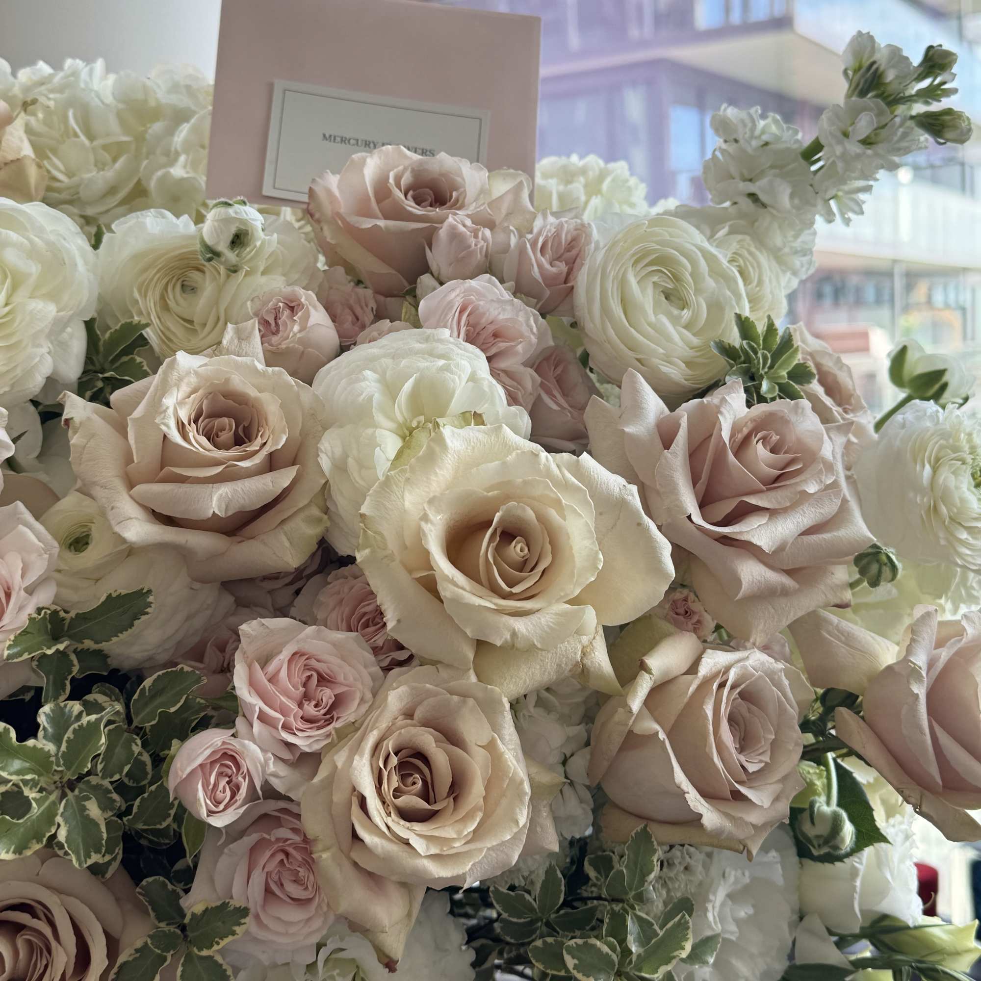 This arrangement features elegant beige nude Quicksand roses with lush garden roses