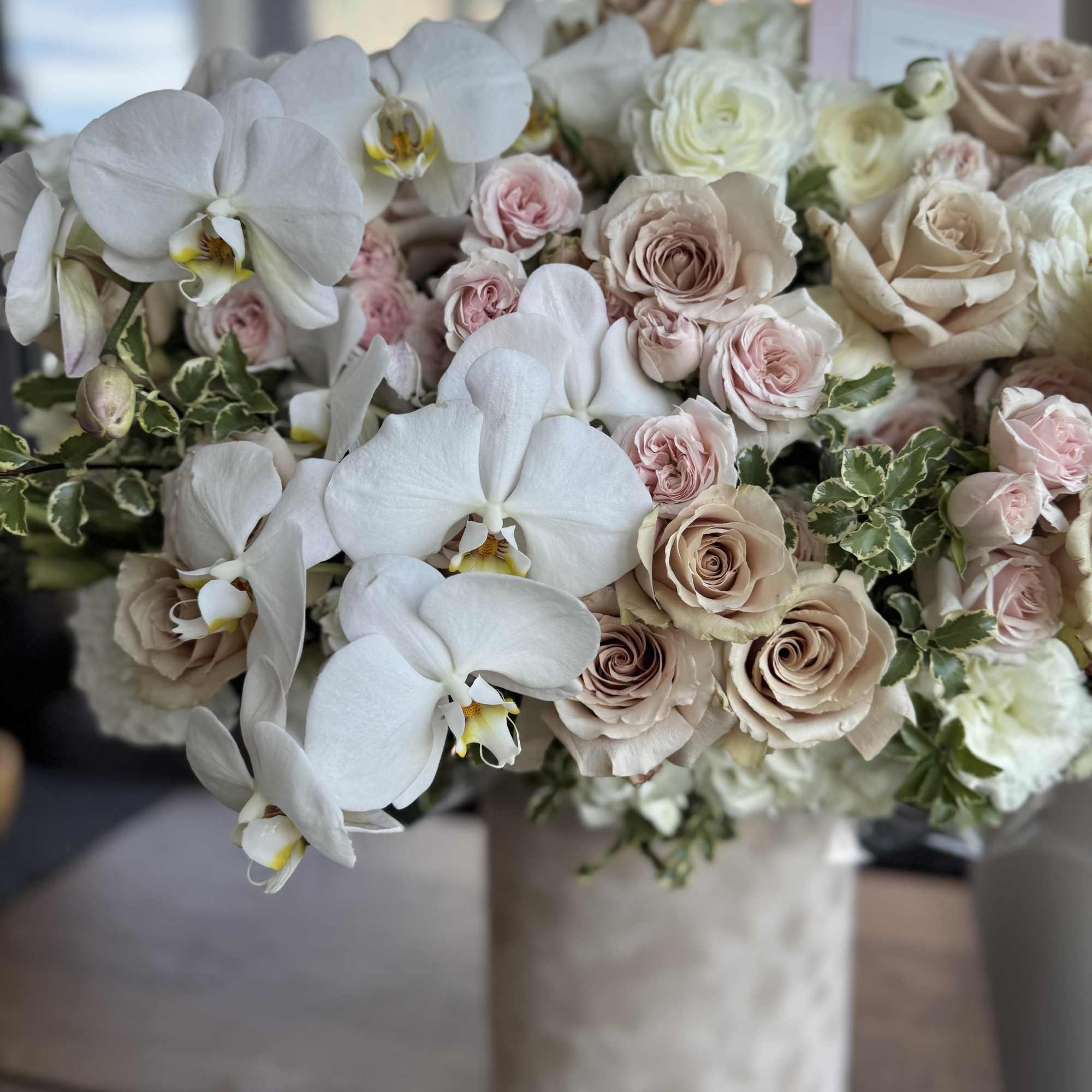 This arrangement features elegant beige nude Quicksand roses with lush garden roses